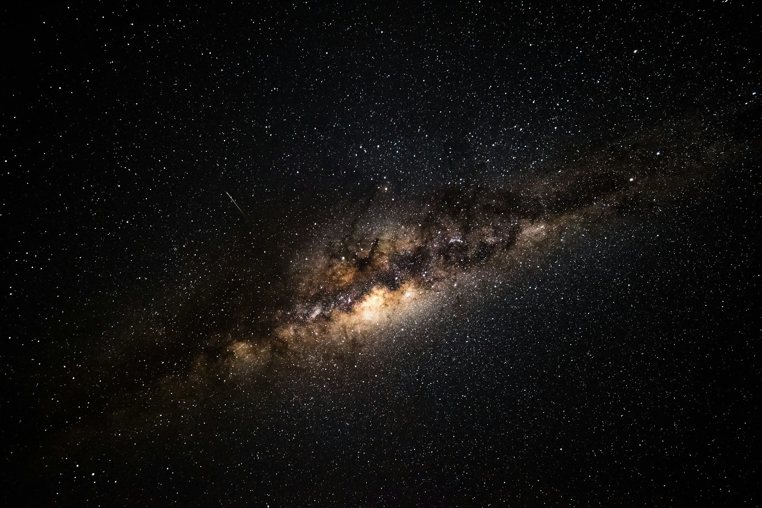 A clear night sky showing the dense star field and the bright core of the Milky Way galaxy with stars scattered throughout.
