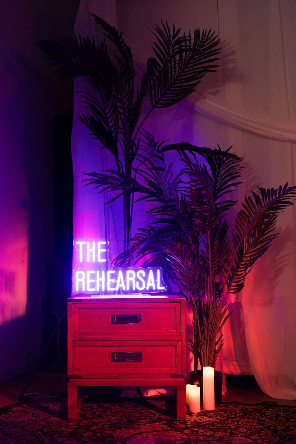 The Rehearsal logo with palm tree at mercado la paloma