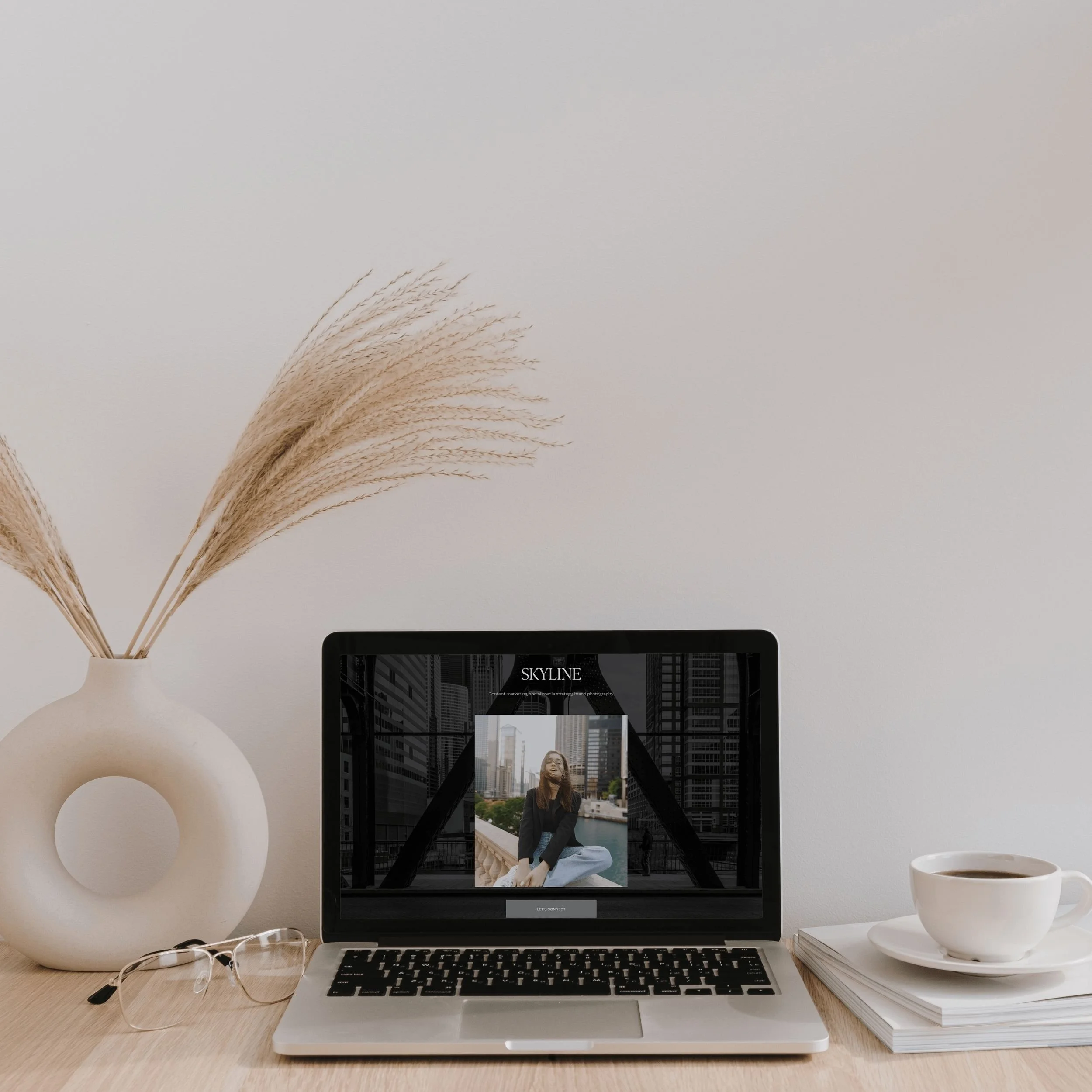 skyline template on laptop with tea cup and vase on desk