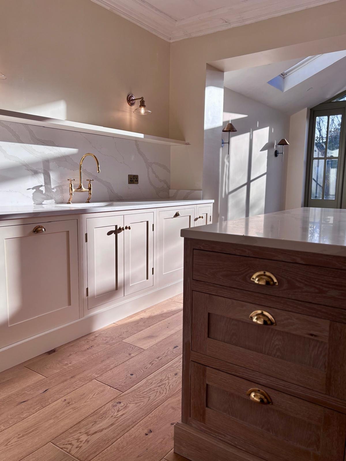 Handmade shaker style kitchen with oak island, quartz worktops and oak flooring in a West Bridgford kitchen extension built by Butterworth & Martin