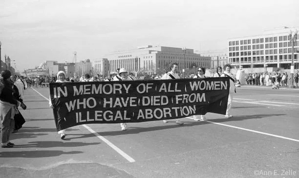 March 09, 1986
View of Pro Choice demonstrators as they carry a large banner on Pennsylvania Avenue NW (between 3rd St SW and 1st St NW) during the March for Women's Lives, Washington DC, March 9, 1986. The banner reads 'In Memory of All Women Who Ha