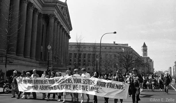 March 09, 1986
View of Pro Choice demonstrators as they carry a banner on Pennsylvania Avenue NW (at approximately 7th St NW) during the March for Women's Lives, Washington DC, March 9, 1986. The banner reads 'We are Your Mothers, Your Daughters, You