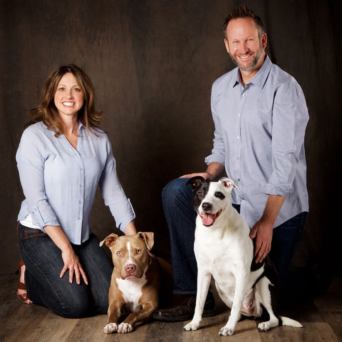Portrait of young couple with two dogs