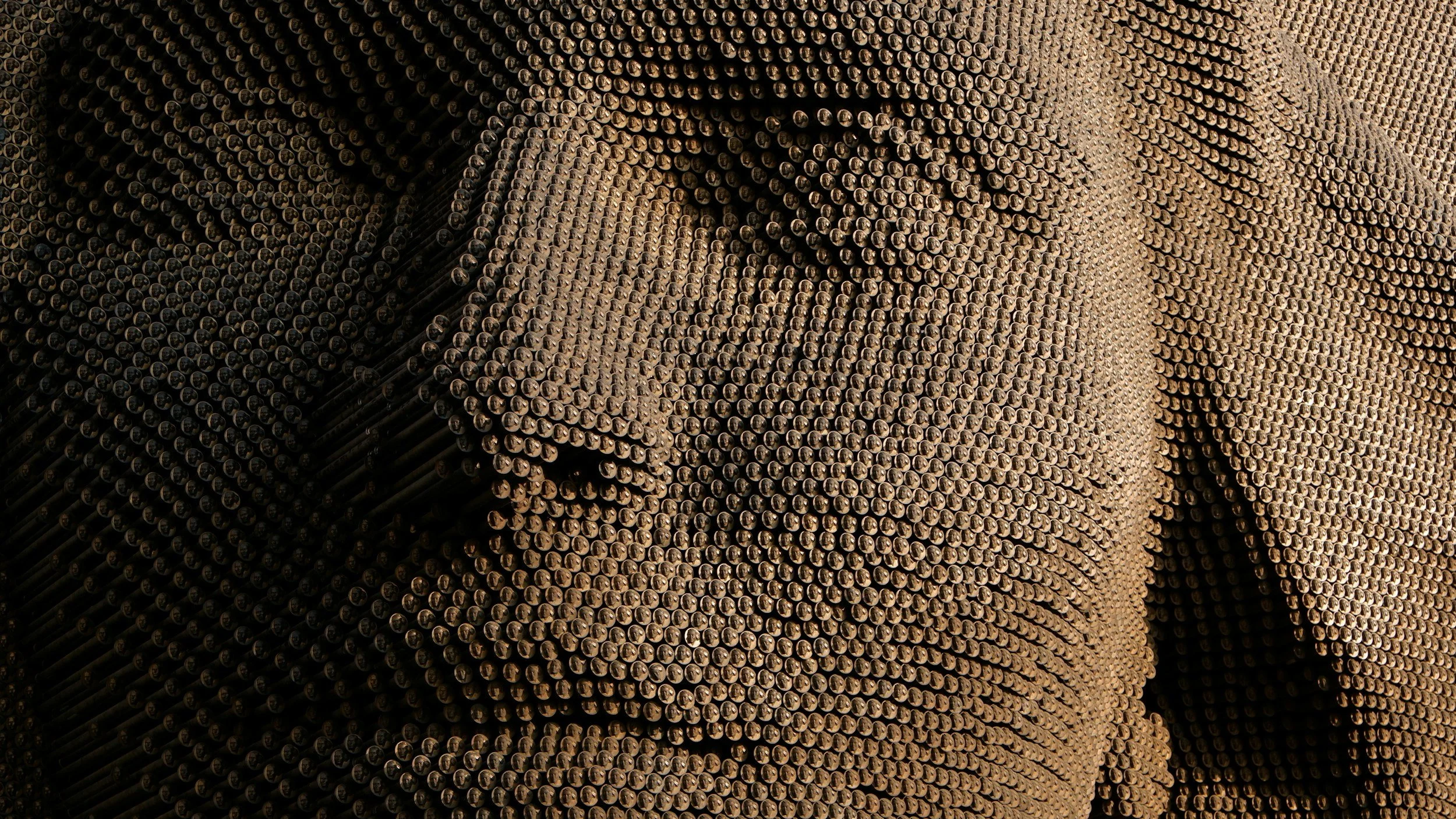 A minimalist architectural facade with vertical rectangular panels and staggered, recessed sections.