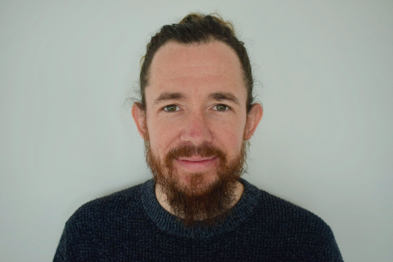 Christopher, a therapist, smiles at the camera