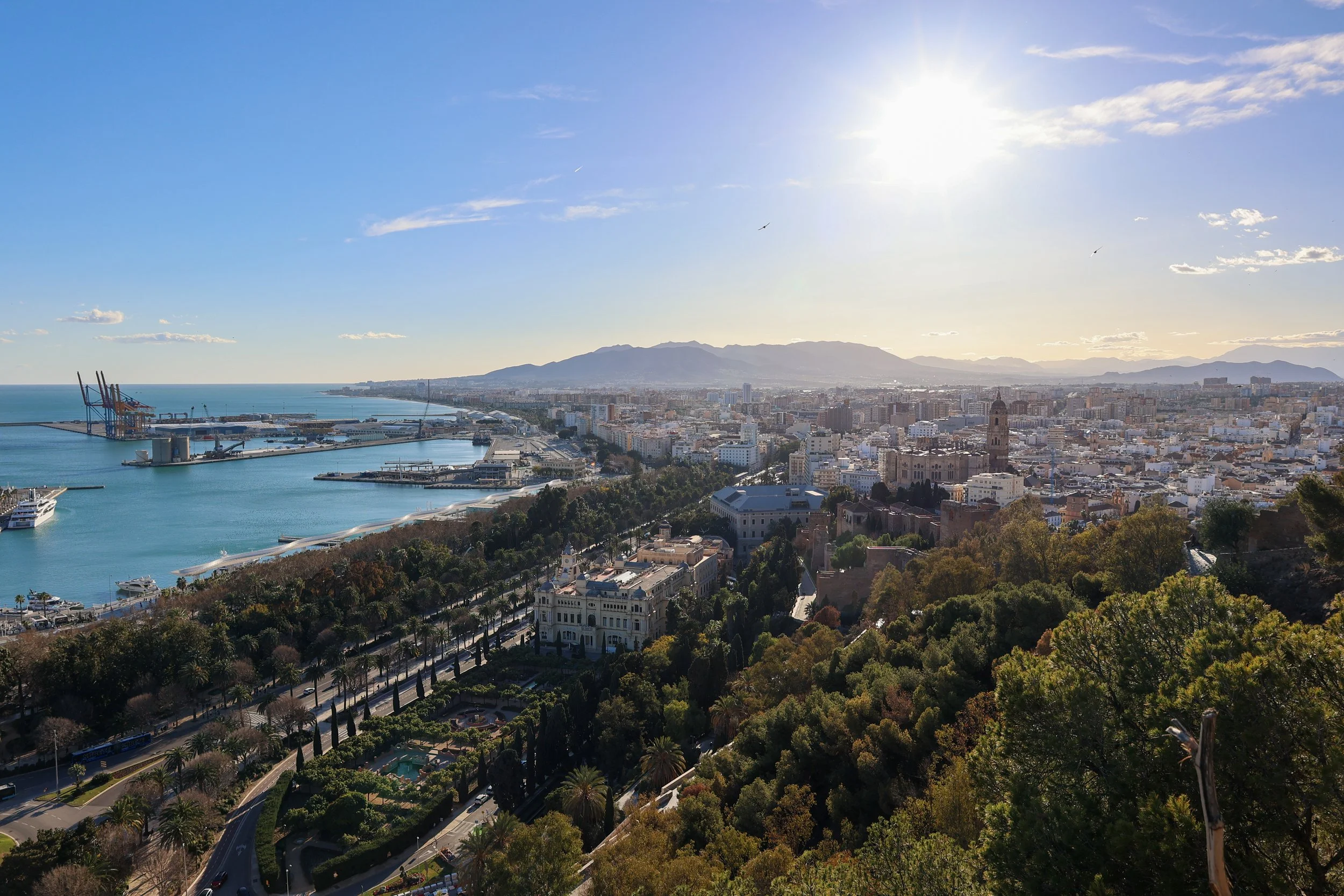 A beautifull panorama view of the city of Málaga, its harbour, the sparkling Mediterranean Sea and iconic landmarks like the majestic Málaga Cathedral and the historic Alcazaba fortress.  Photograph by Joyce Spierenburg.