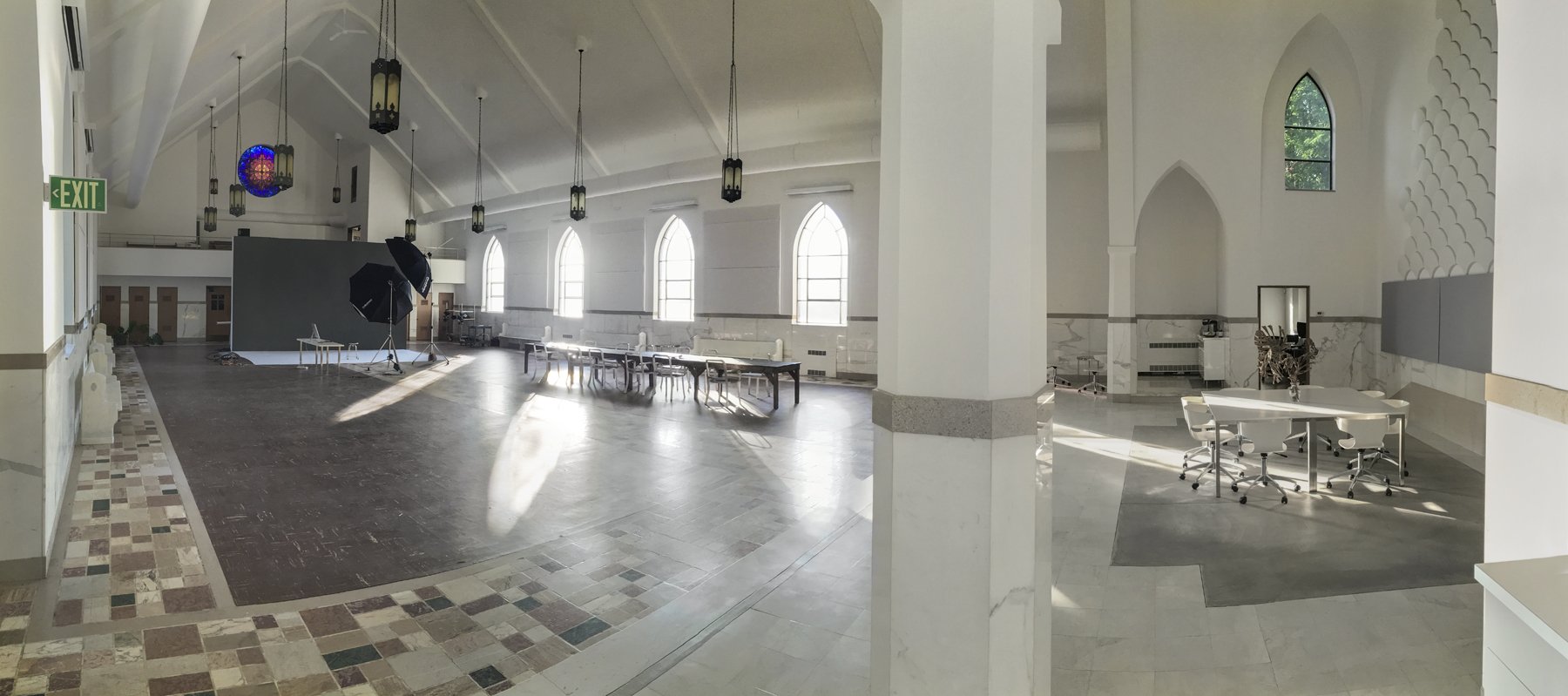 Inside the 57th Street Portraits studio, a bright former church with tall windows and white columns