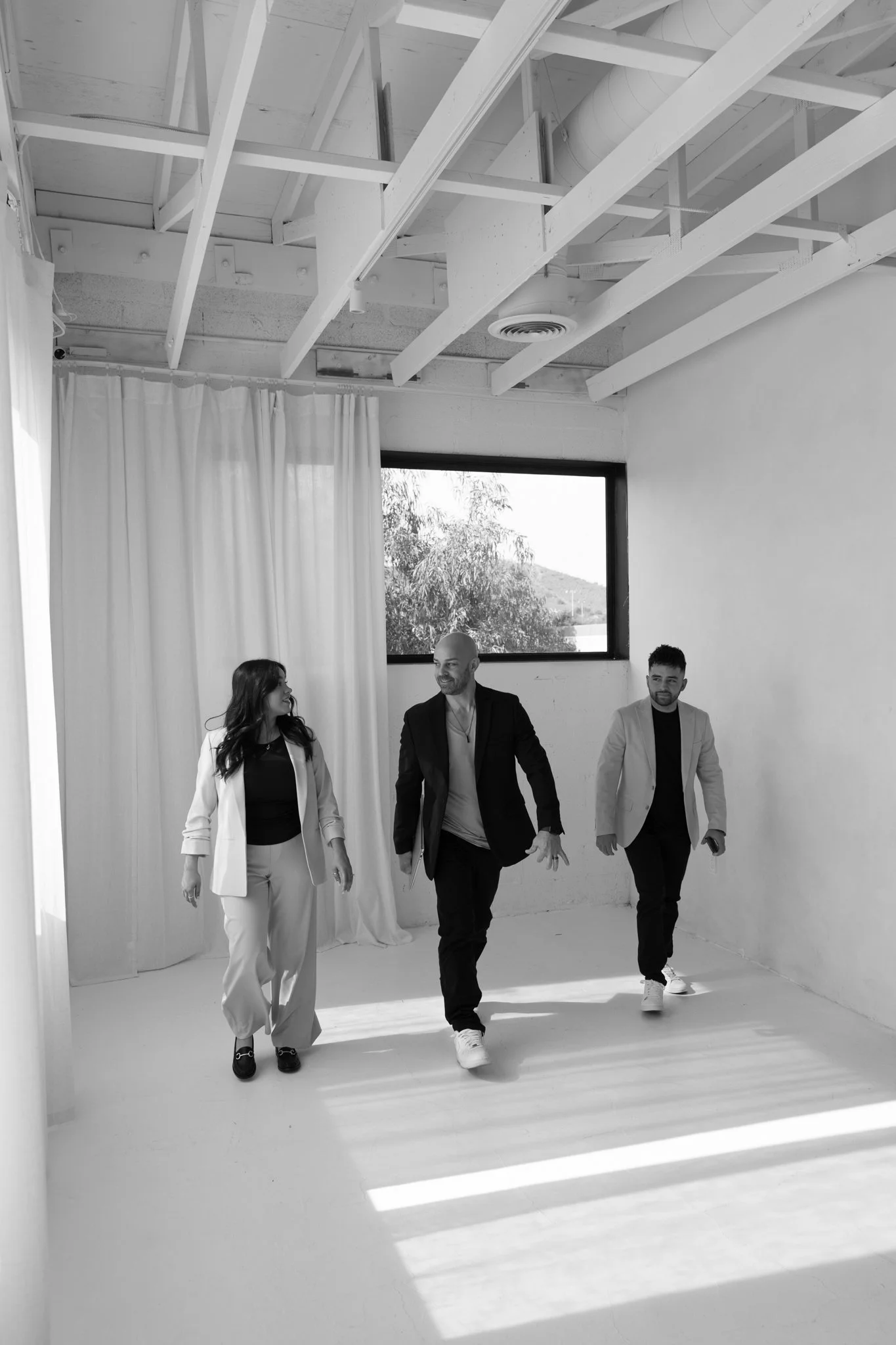 The Legacy Team mortgage professionals walking together while discussing home loan solutions.