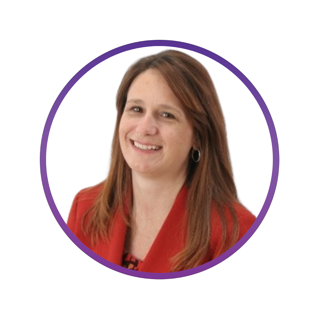 A woman with shoulder-length reddish-brown hair, wearing a red blazer and smiling.