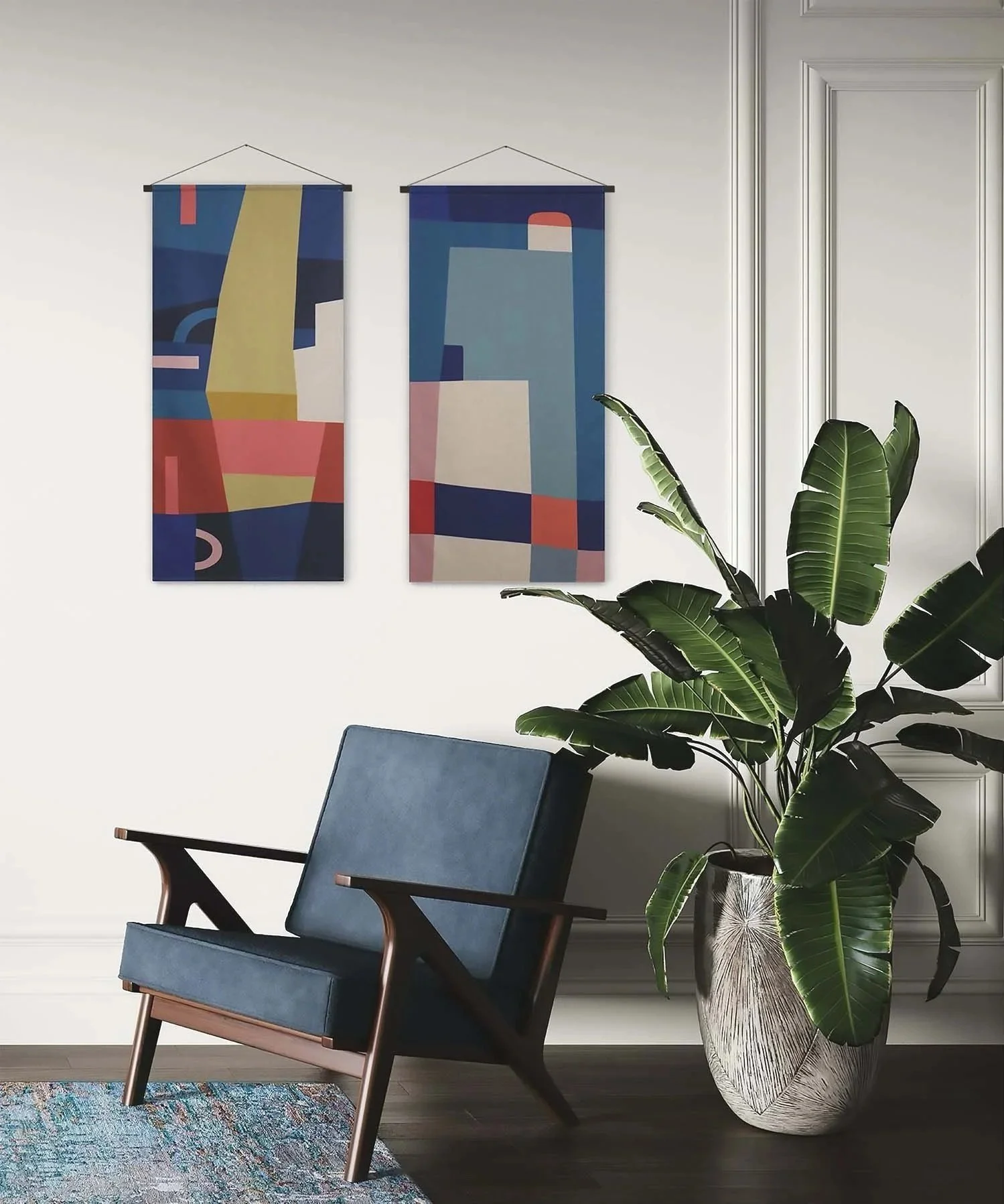 A modern interior space with a blue armchair, large potted plant with broad green leaves, colorful abstract art hanging on a white wall, and a patterned area rug.