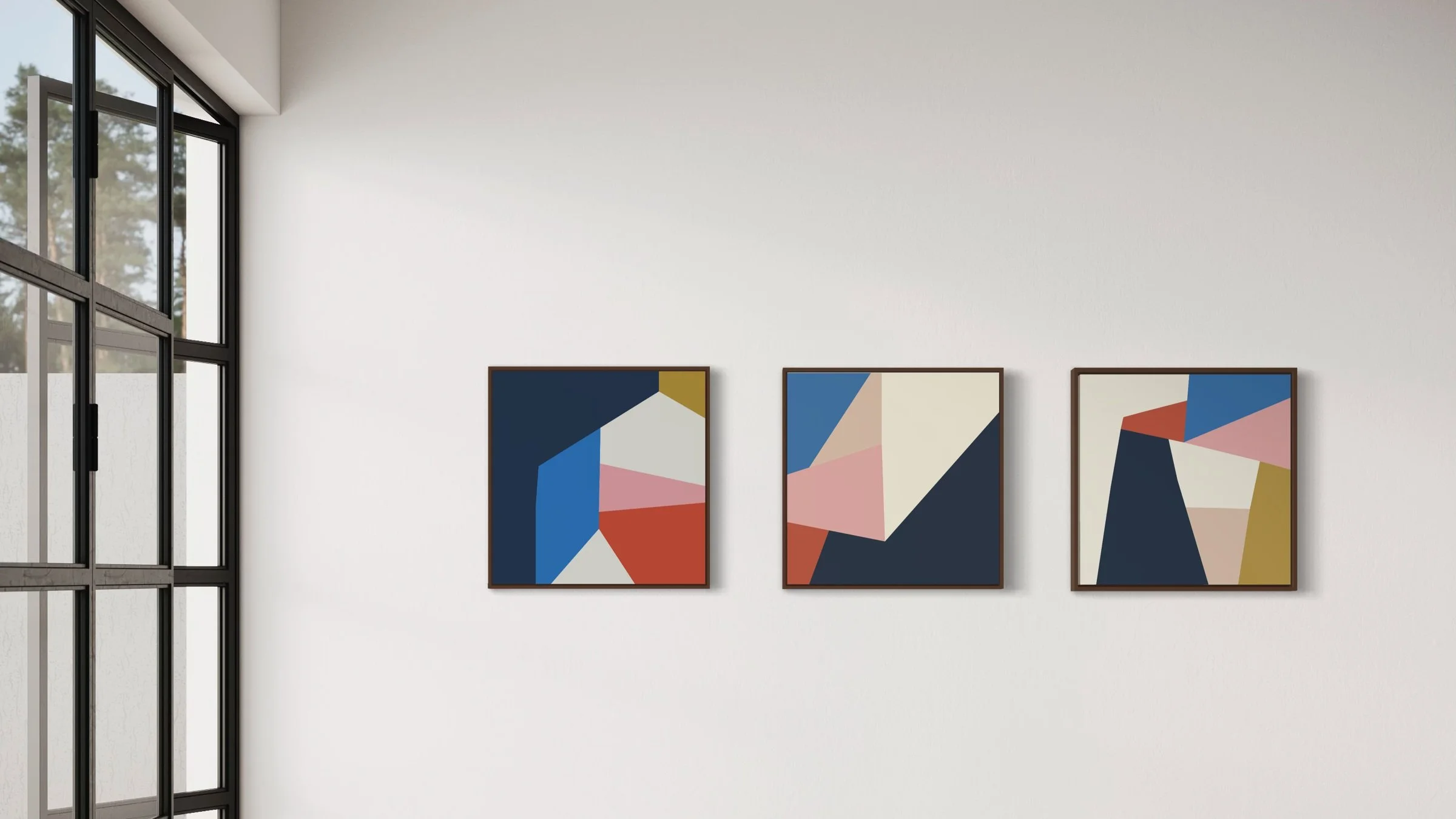 Three abstract colour block giclee prints hanging on a wall