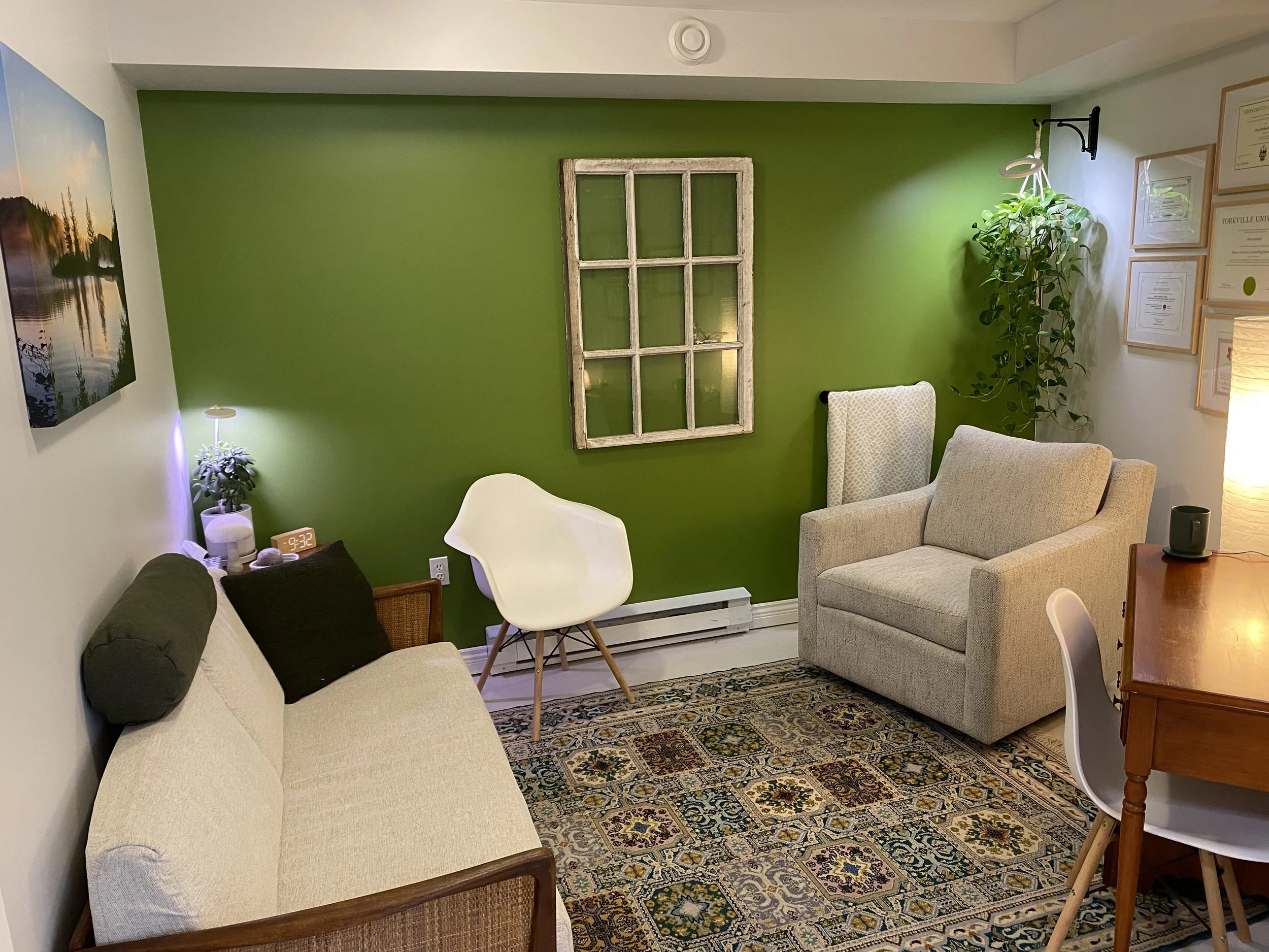 Counselling treatment room, warm and cozy with natural plants and warm lighting