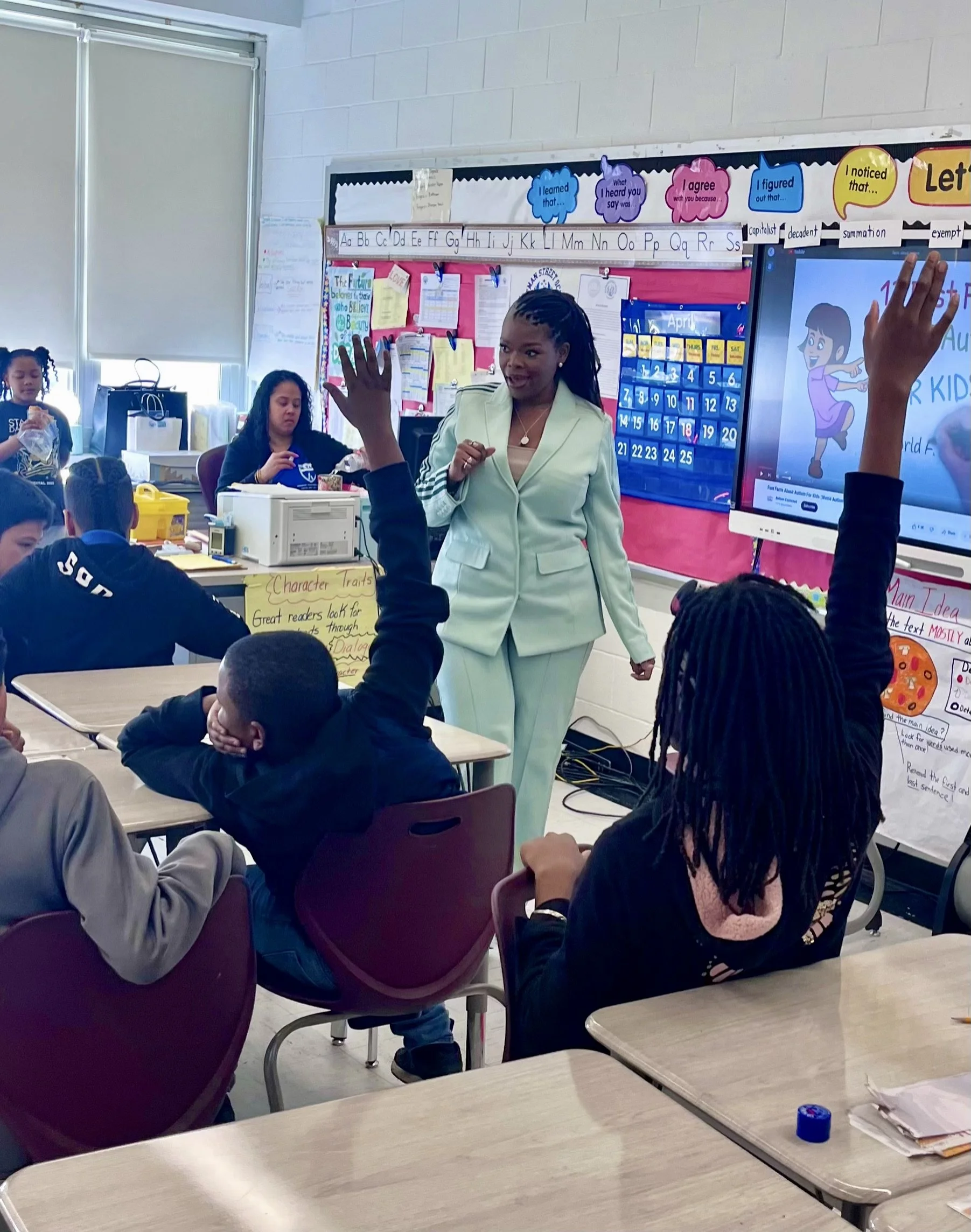 Tiffany Monique speaking to student for career day