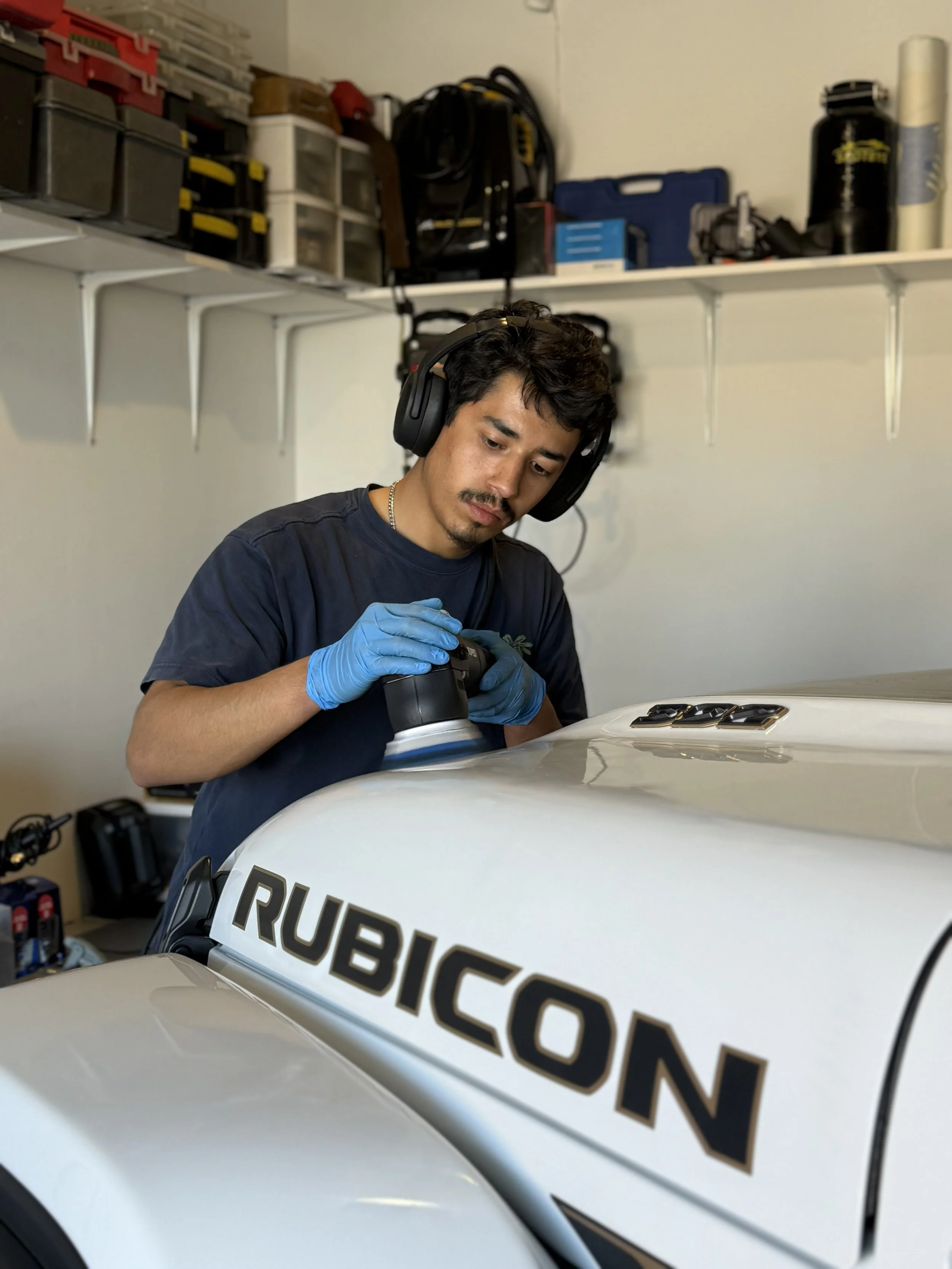 Auto detailer performing paint correction with dual action polisher in Albuquerque