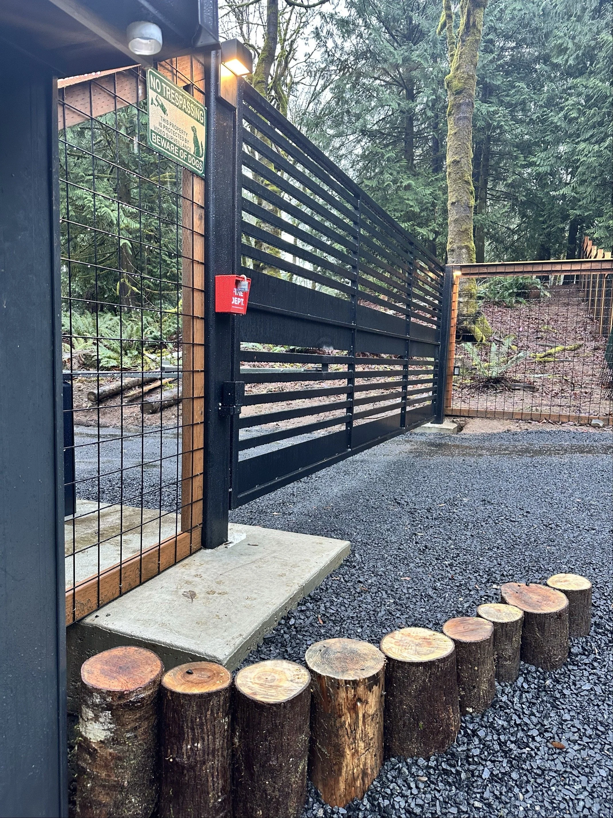 A specialized automatic gate with custom landscaping accents and a modern design.