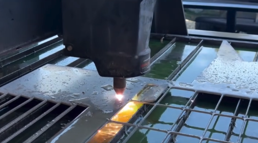 An advanced CNC plasma gun cutting individual pieces out of a sheet of metal on a plasma table.