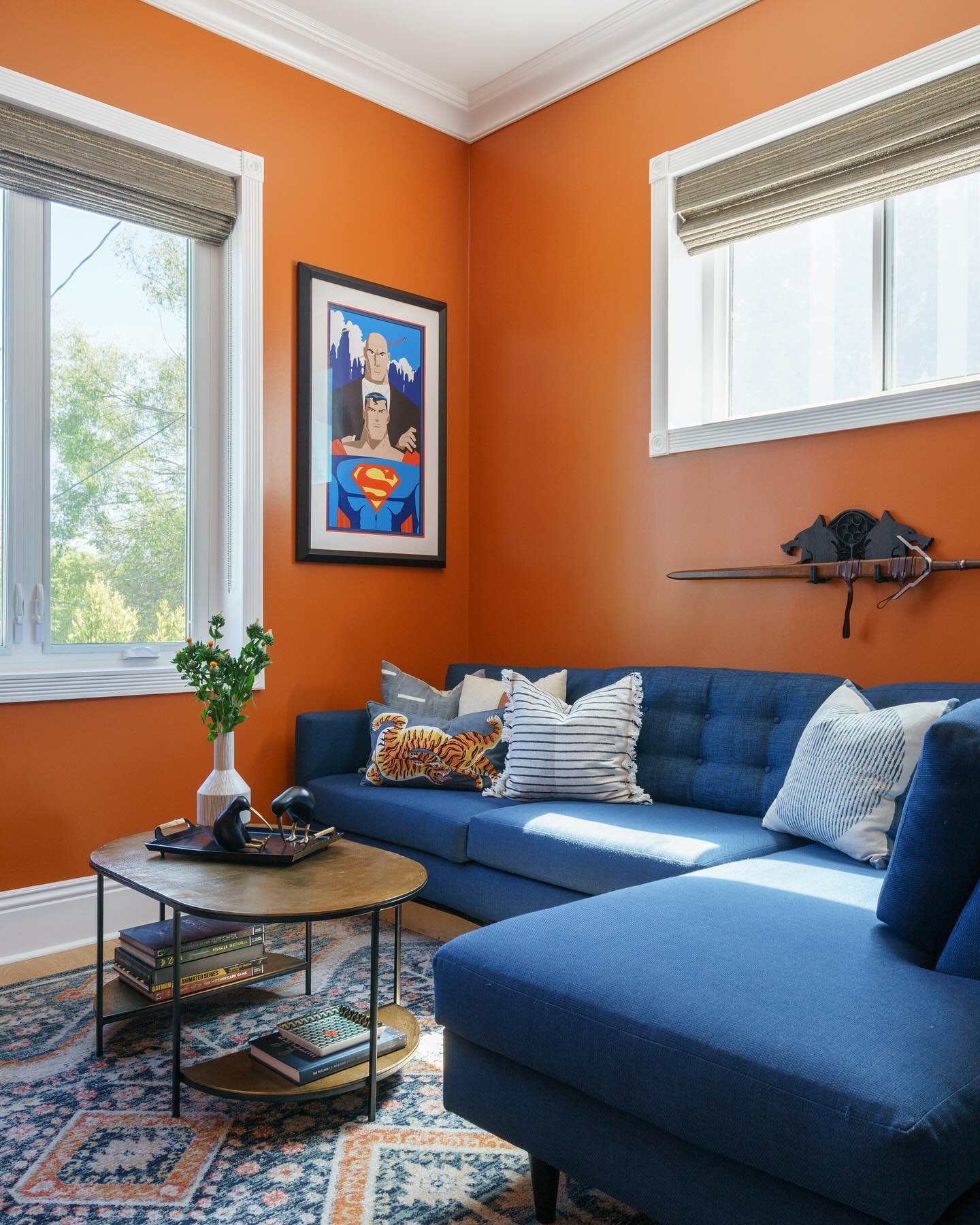 Superman and Samurai Swords for this vibrant man cave with @benjaminmoore&rsquo;s Gold Rush paint color 🖌️🧡

design: @nicolefaydesign 
.
.
.
.
.
.
#interiordesign #interiorinspo #sharemystyle #walltowallstyle #homedesign #adstyle #sodomino #howwedw