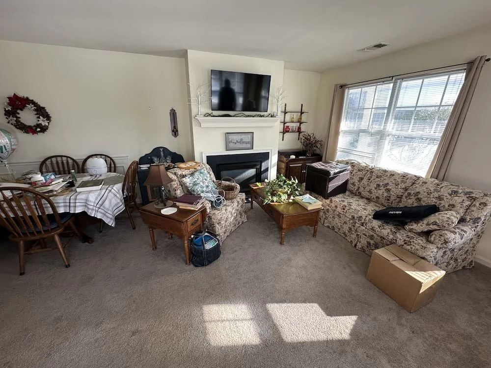 Cluttered living room before estate cleanout