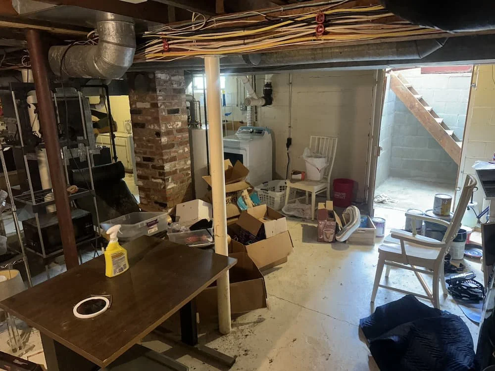 Junk piled in basement before basement cleanout