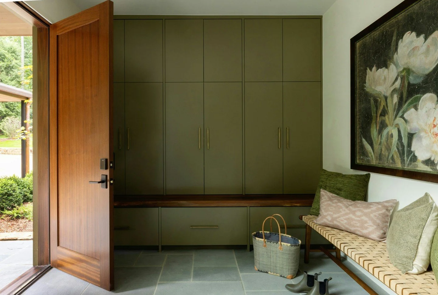 Everyday spaces deserve just as much attention as the main rooms. For our client, a well-organized entryway into the mudroom was essential: custom cabinetry for storage, durable flooring, and warm details that make coming and going feel effortless. P