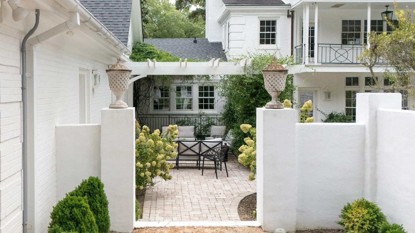 Rooted in Southern tradition, this exterior balances timeless charm with modern function after undergoing several internal & external renovations over the last ten years with our WJBC team.
Whitewashed brick, shaded porches, and intimate courtya