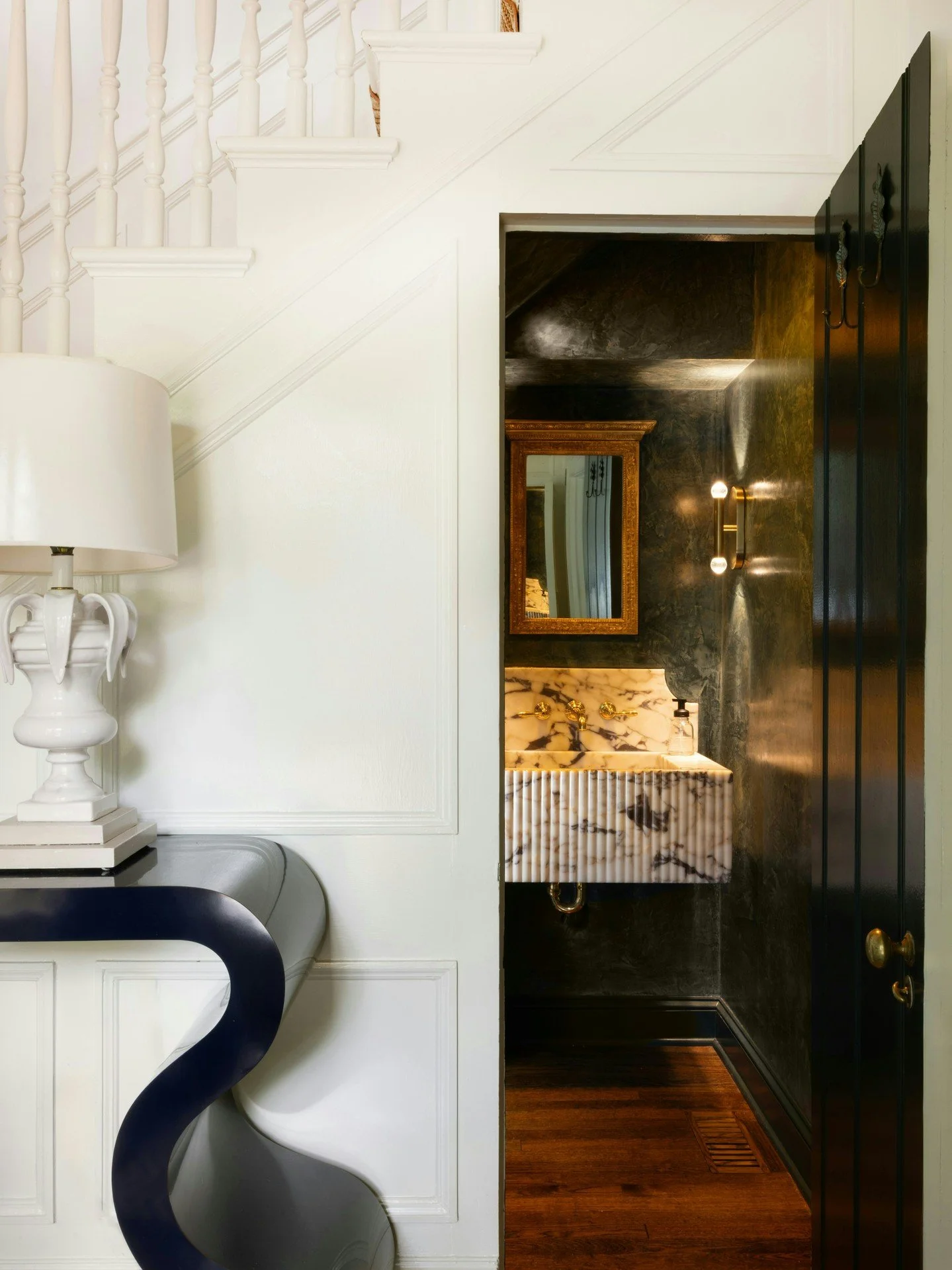 A small footprint, a big moment. Tucked beneath the stairs, this powder room became the house&rsquo;s most unexpected showpiece.

Photography: Aura Lake Photography