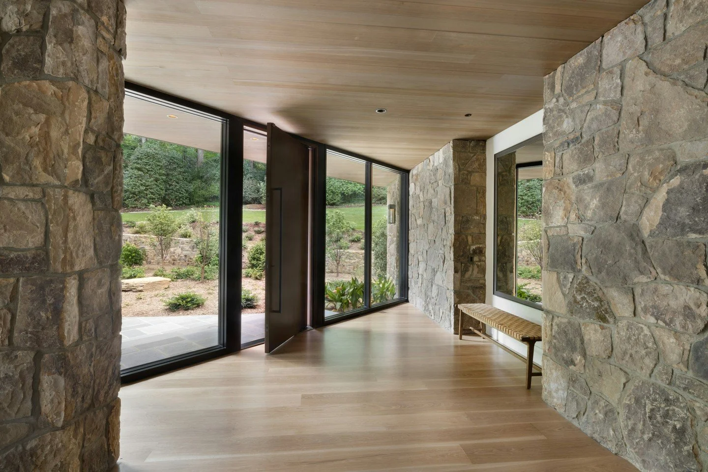 Crafted to create a natural flow between inside and out, this impactful home uses materials that feel grounded in the landscape, from the stacked stone exterior to the copper detailing and steel accents. Large windows and thoughtful transitions invit