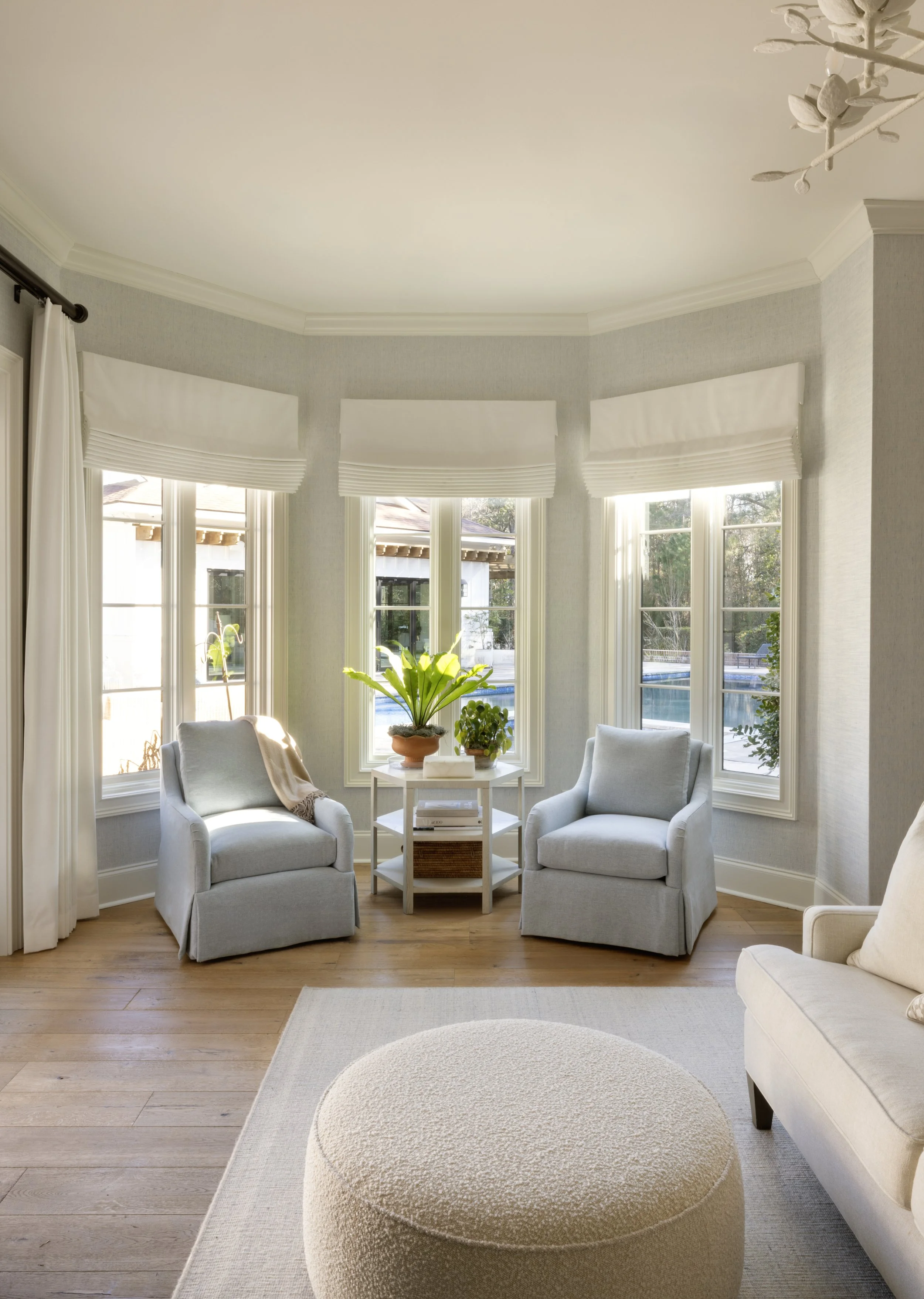 Modern transitional sitting area with large windows overlooking a custom home's outdoor living space