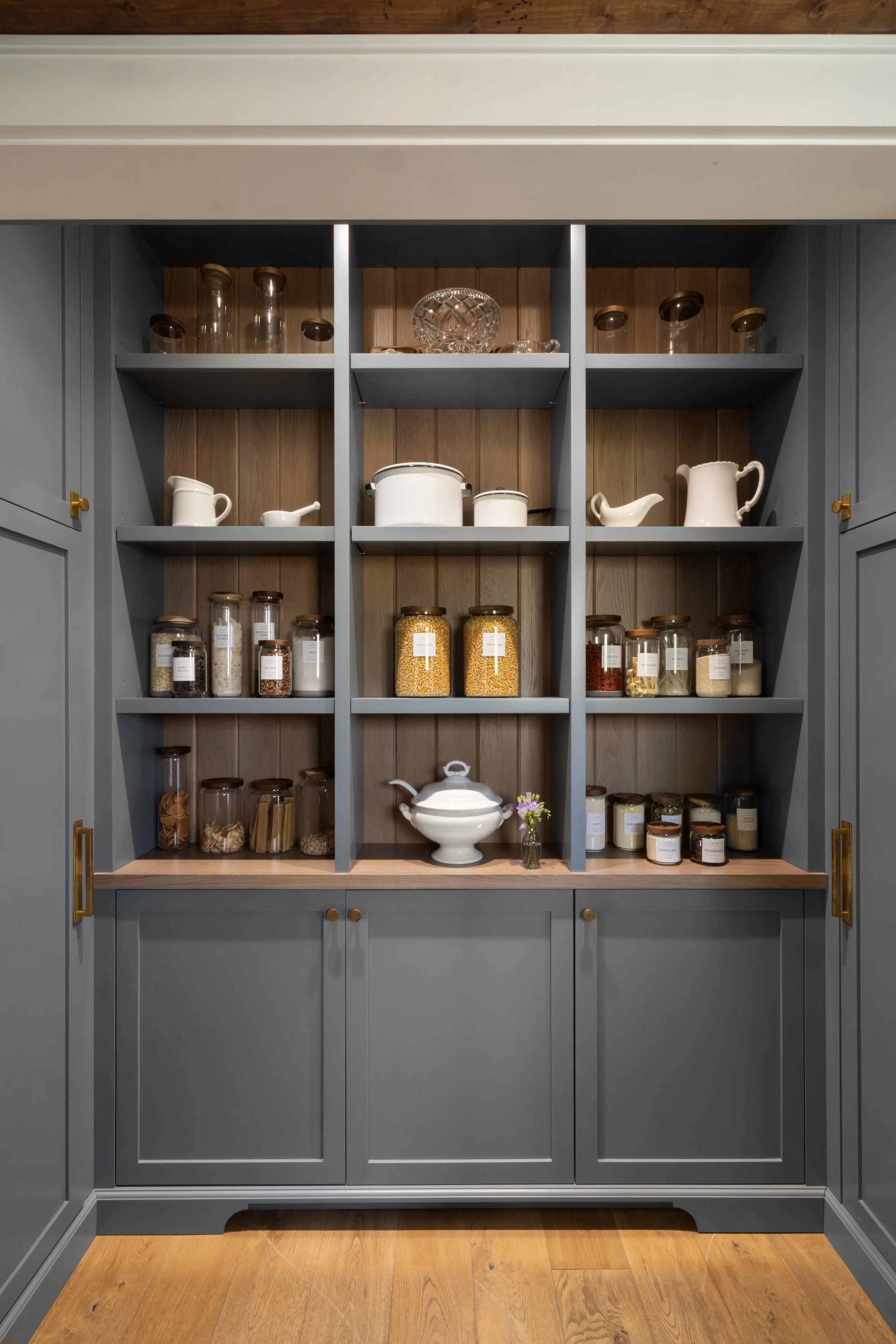Pantry interior of a luxury custom home by Will Johnson Building Company in the Triangle NC featuring built-in cabinetry, open shelving, and organized storage design