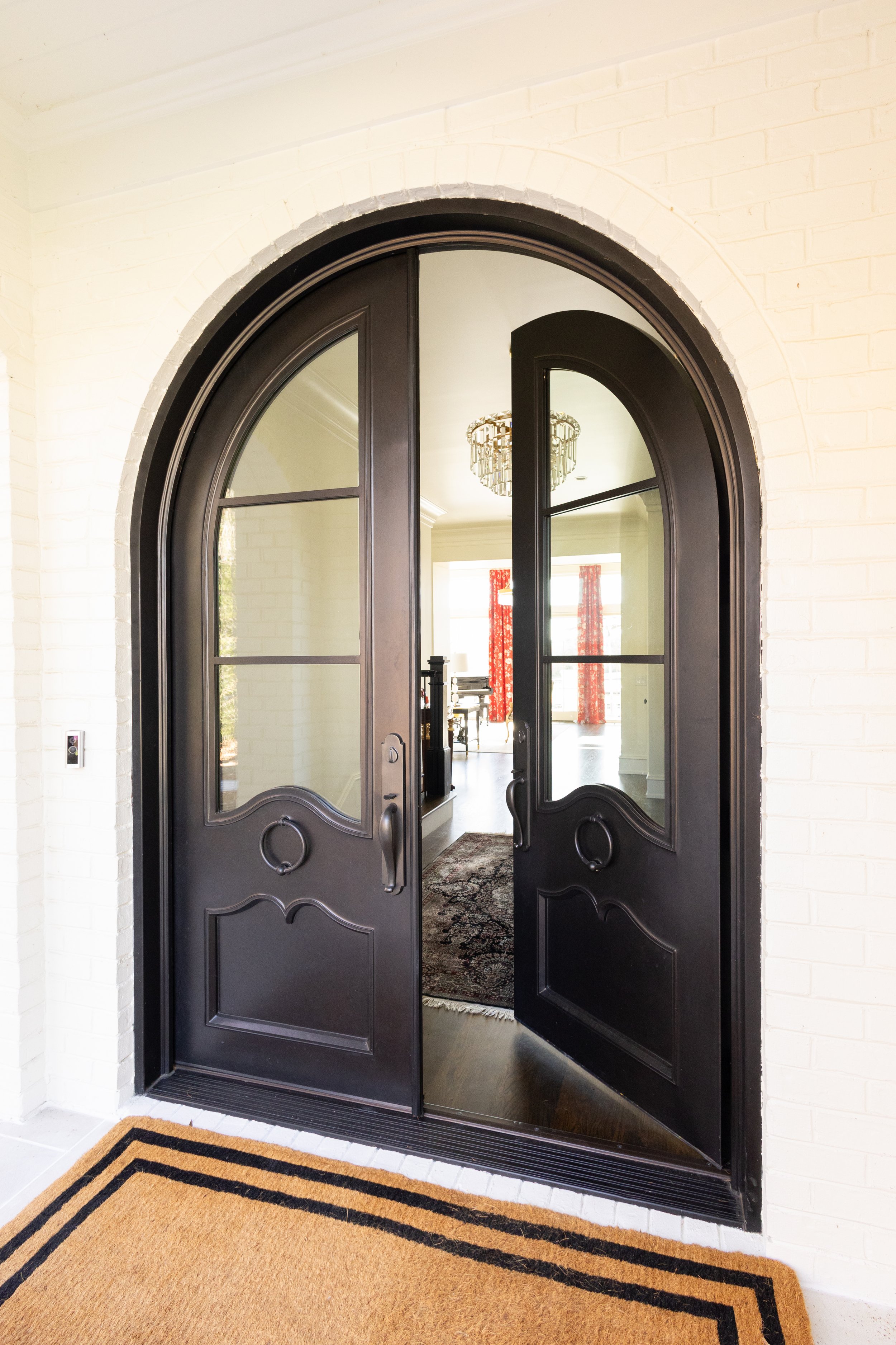 Modern transitional front entry with wide arched doorway and accessible double entry doors