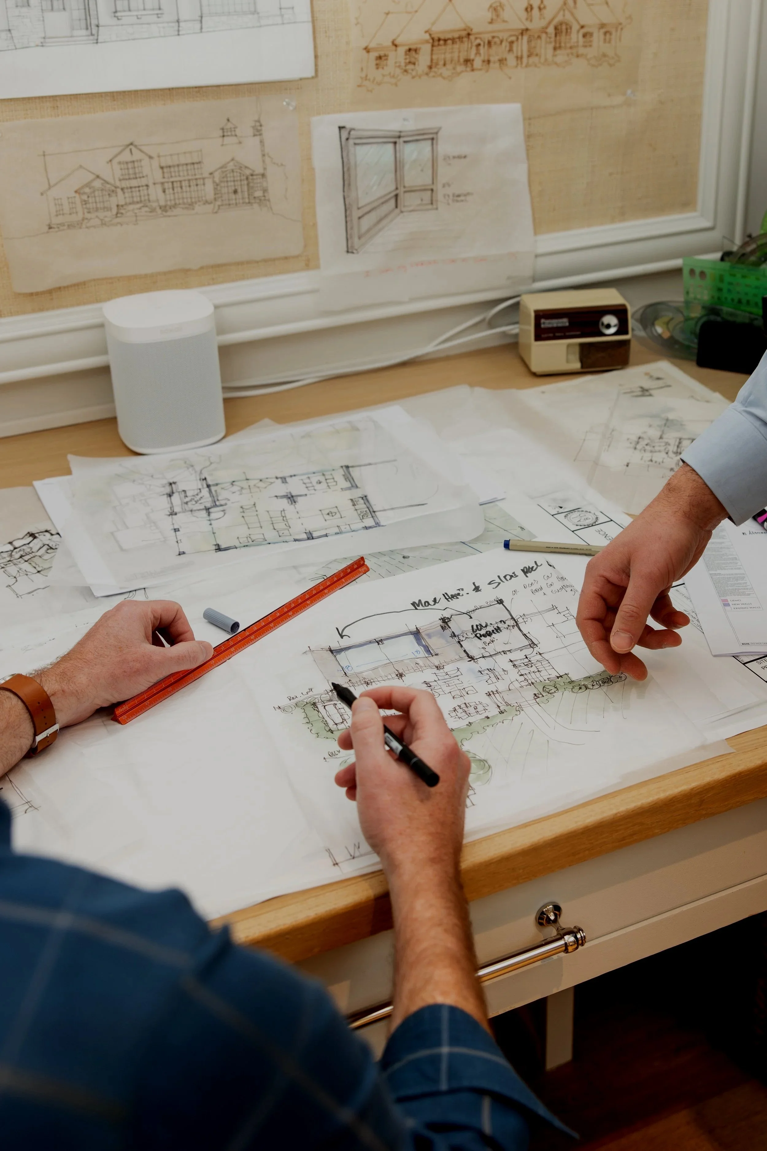 Custom home design planning session by Will Johnson Building Company in the Triangle NC showing detailed floor plans, sketches, and hands-on collaboration during the residential design process