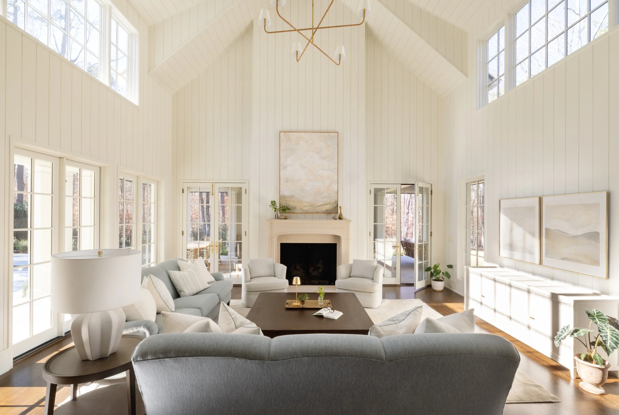 Great room interior of a luxury custom home by Will Johnson Building Company in the Triangle NC featuring vaulted ceilings, large windows, fireplace, and open living layout