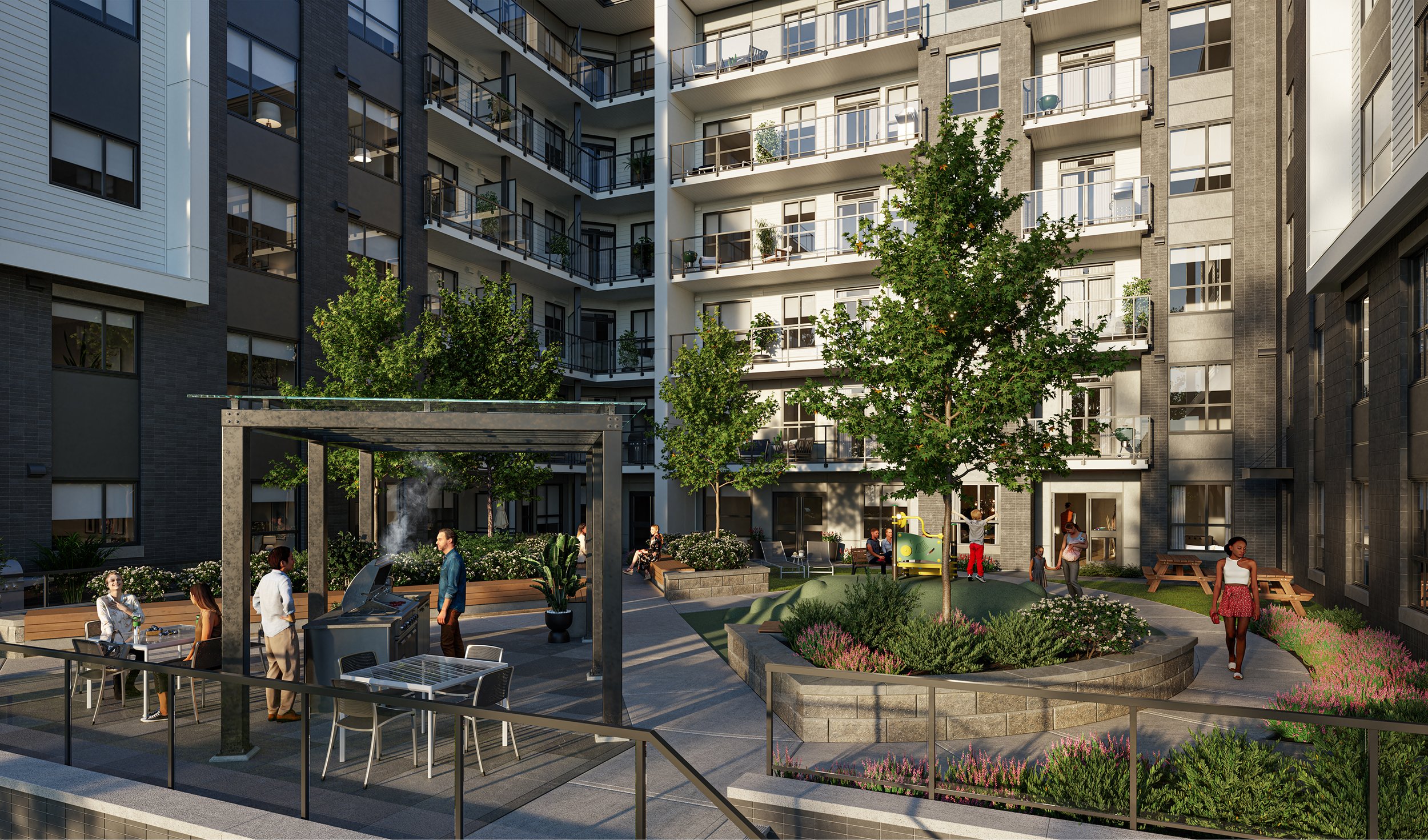Courtyard amenity between residential wings, with a barbecue pergola, dining tables and a lawn with a play area under a mature tree