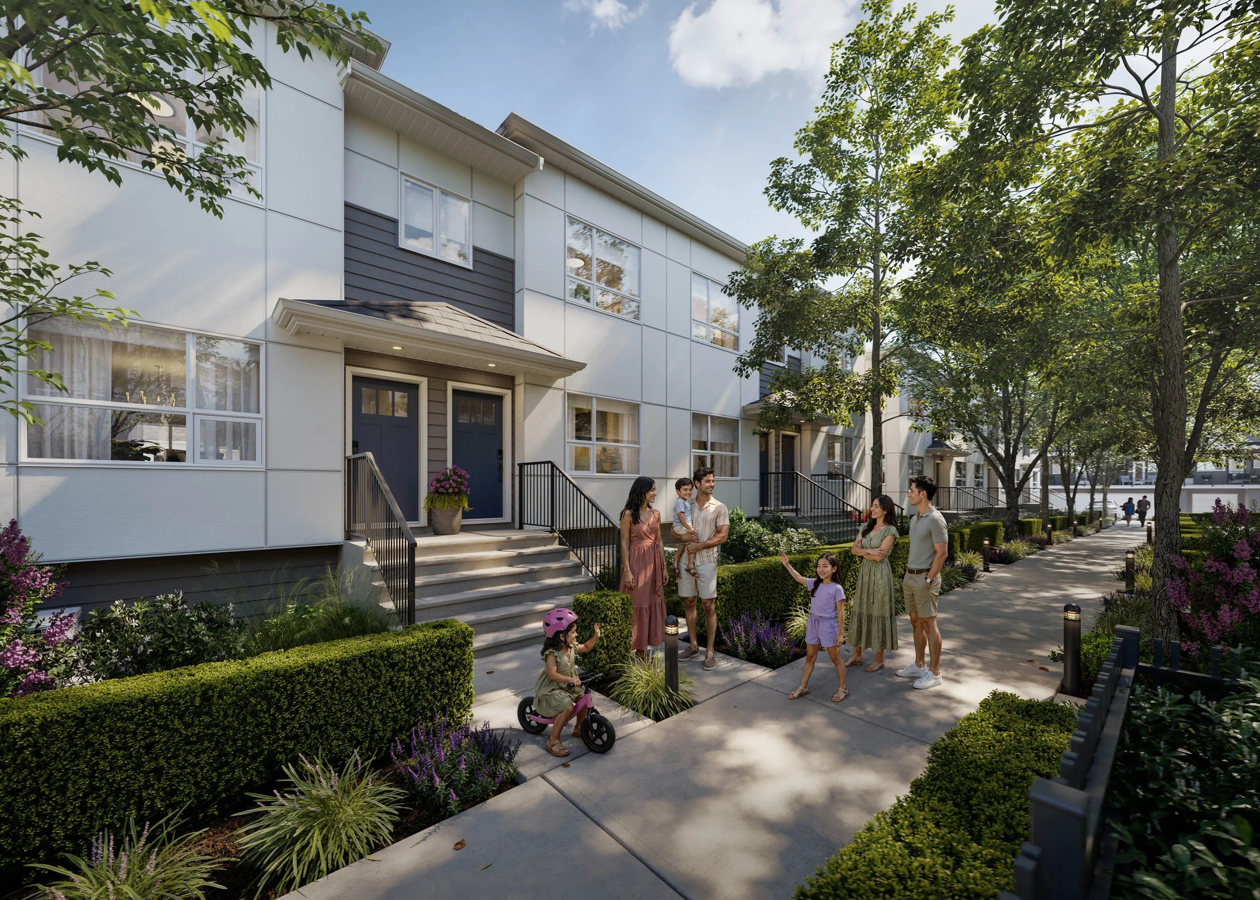 Pedestrian street between two townhome rows, with families gathered by a front stoop, a child on a balance bike and planted garden beds