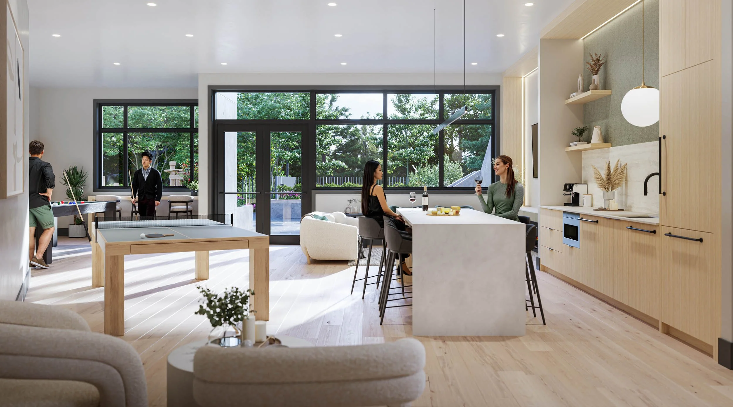 Amenity lounge with a billiards table, a pale kitchen island with bar stools, soft seating and full height glazing onto the garden