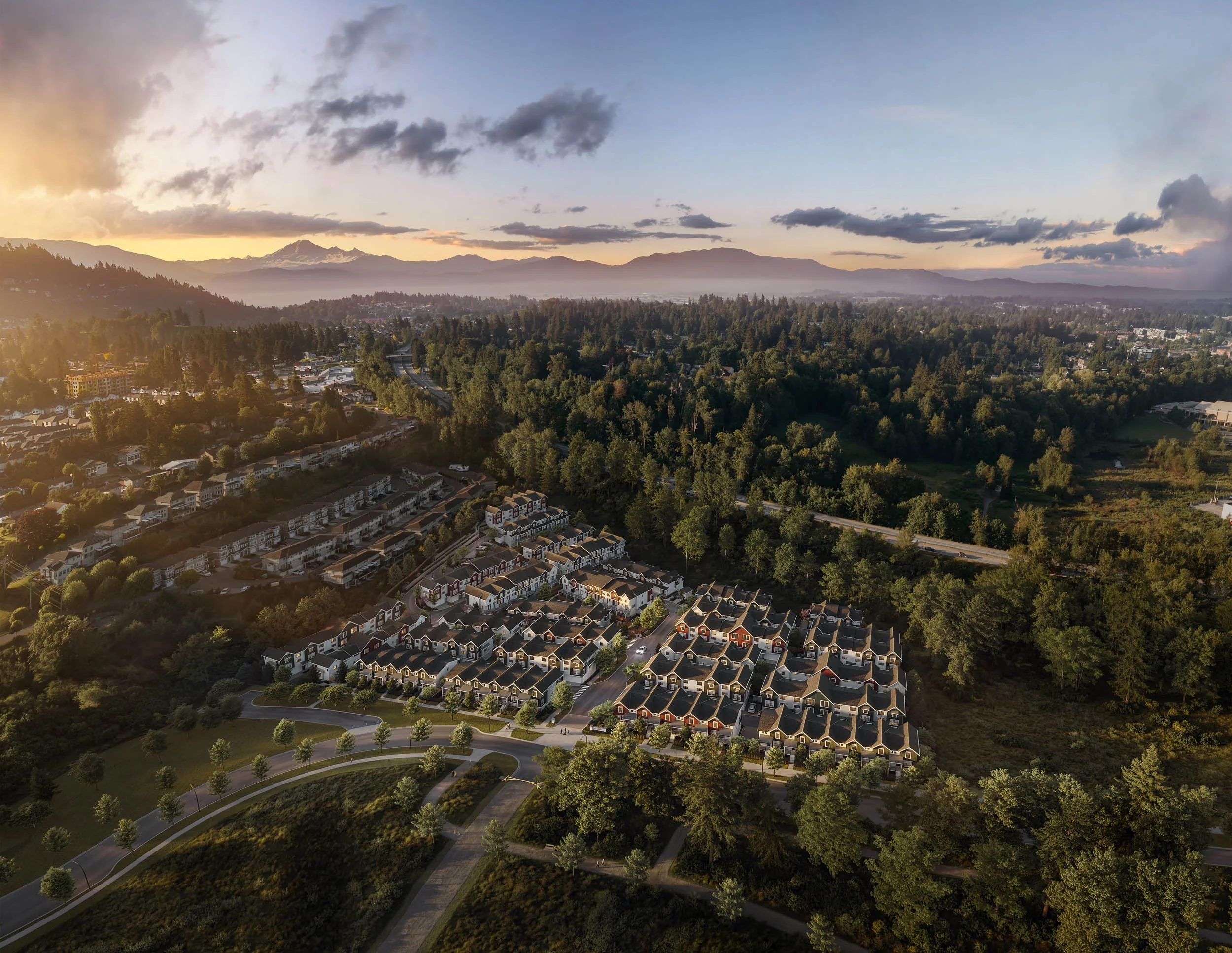 Aerial view of a townhome masterplan in a forested valley at sunset