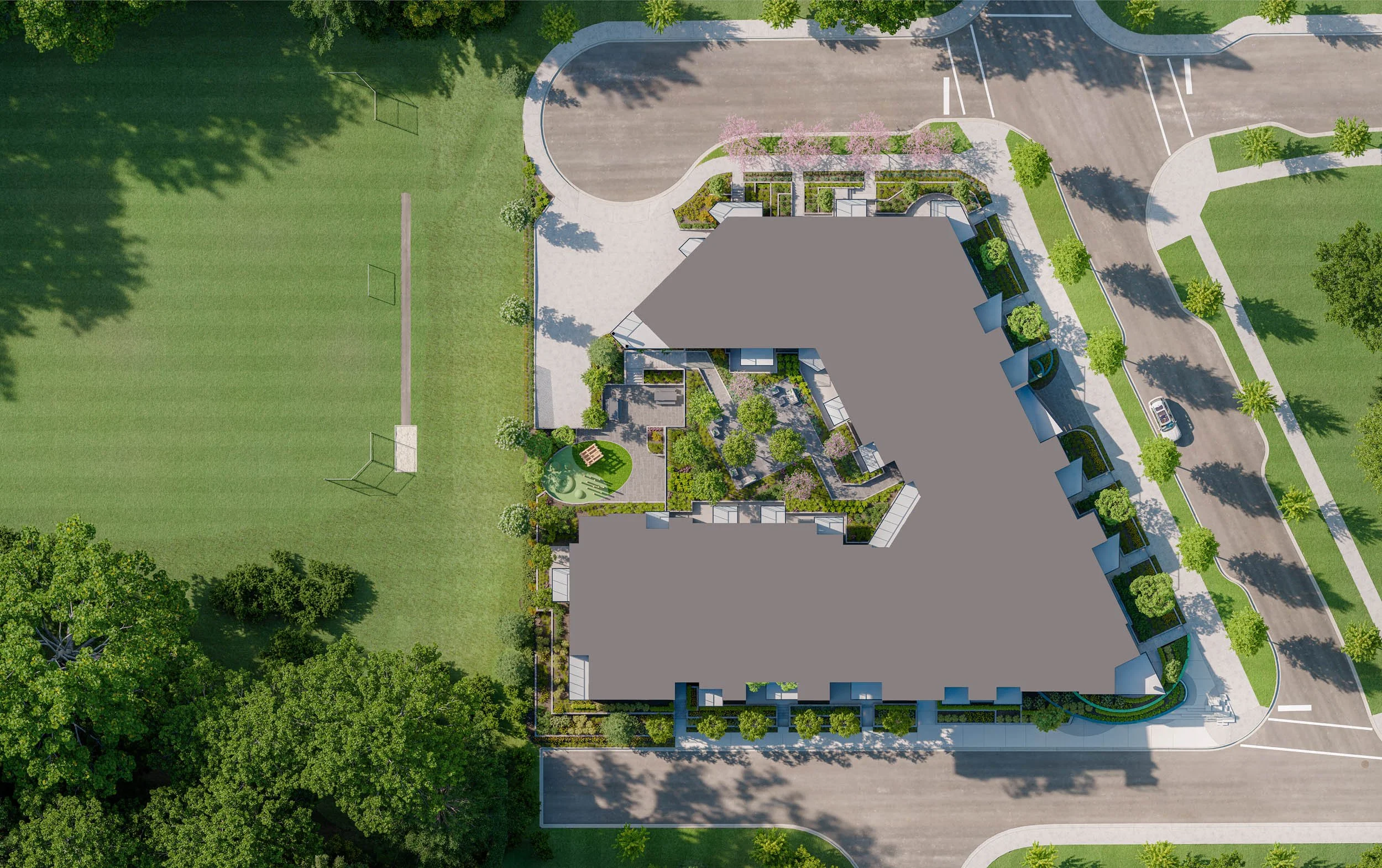 Overhead plan of the development in its block, the building drawn as a solid grey footprint among landscaping, street parking and a large green playing field