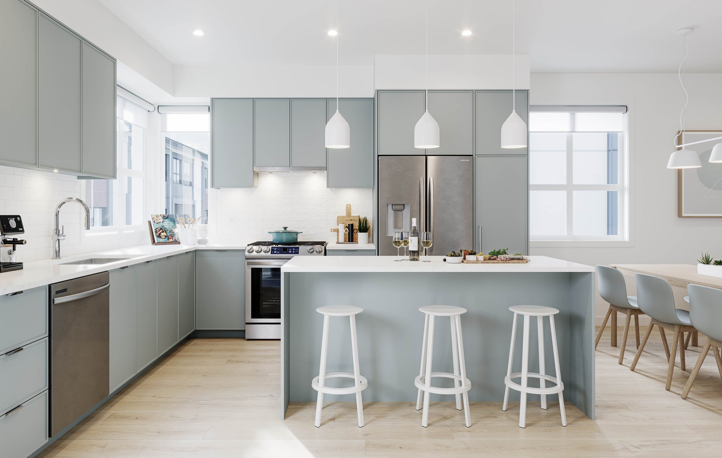 Kitchen with sage green cabinetry, a white quartz island and three white stools, pendant lights, stainless appliances and a dining table beyond