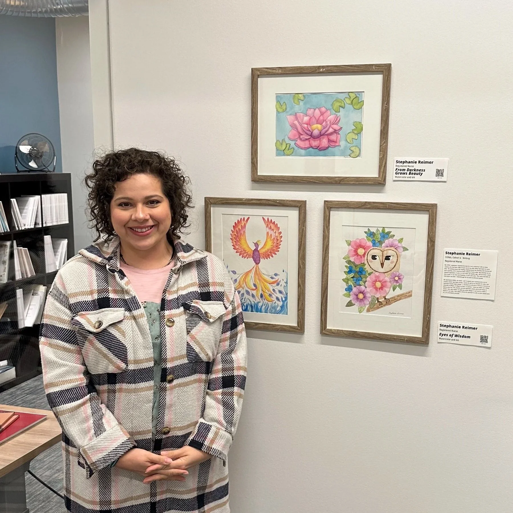 Stephanie standing next to her artwork displayed at the CORAL traveling exhibit