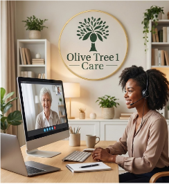 Woman on a video call in front of a computer at her desk with a sign that says Olive Tree Care in the background.