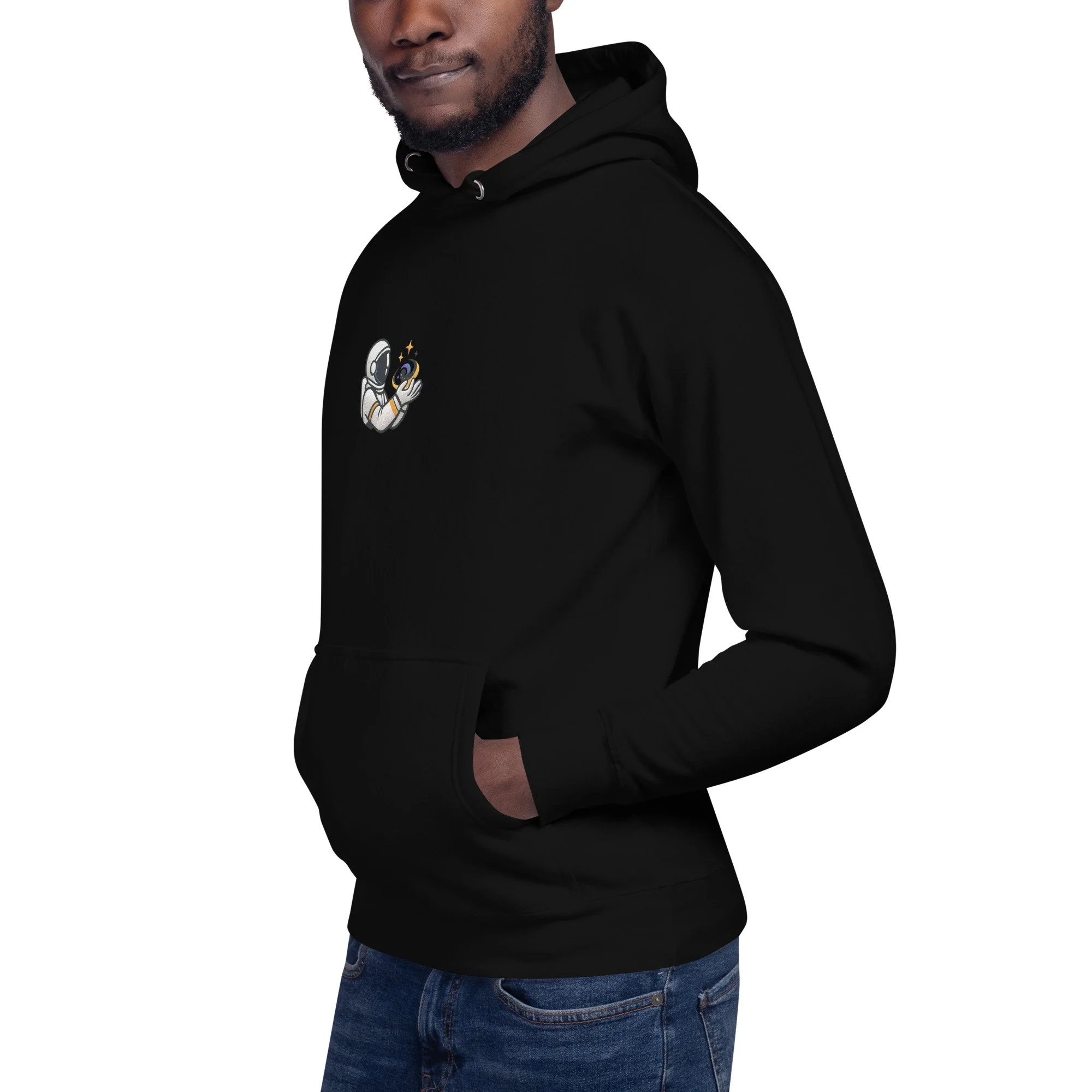 Angled view of the black “Universe Holder” hoodie on a model, highlighting the astronaut holding a tiny galaxy design.