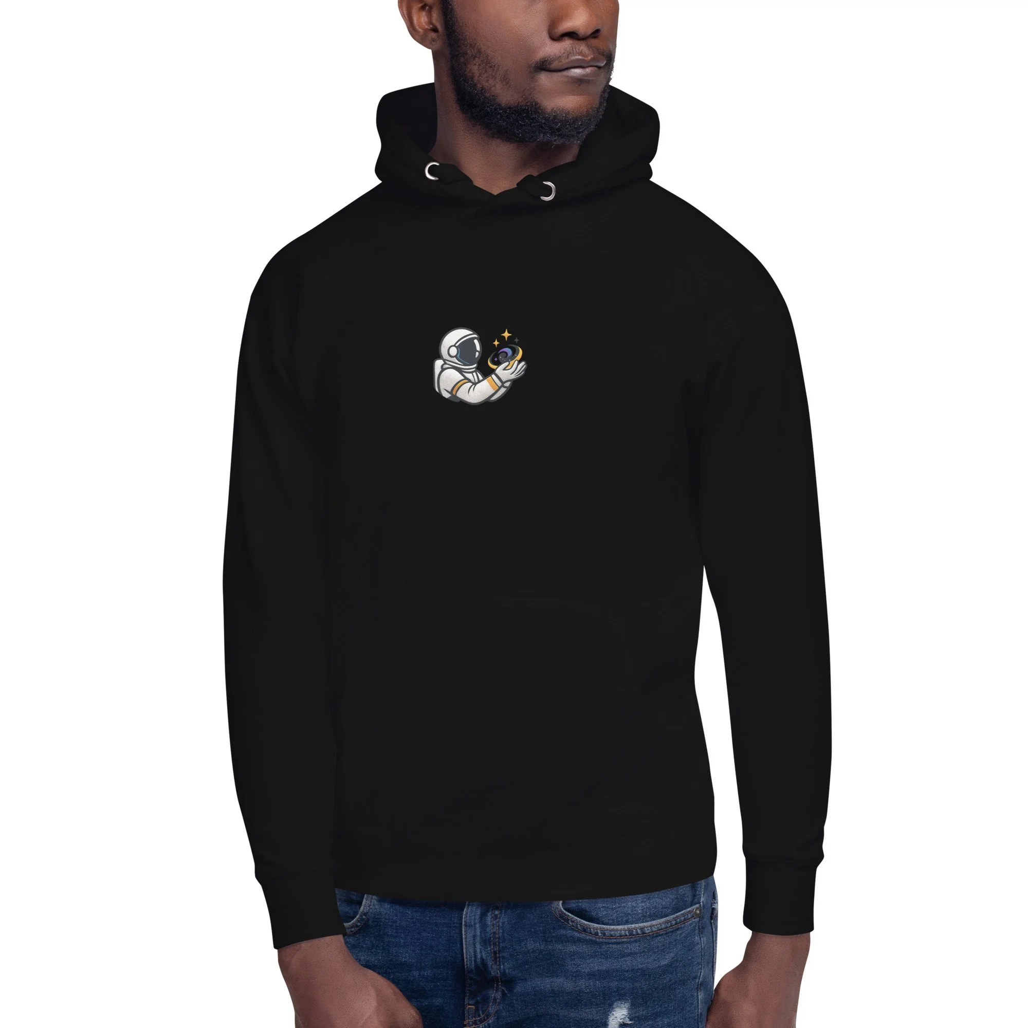 Front view of the black “Universe Holder” Evolvv hoodie worn by a model, showing a small astronaut holding a galaxy on the chest.