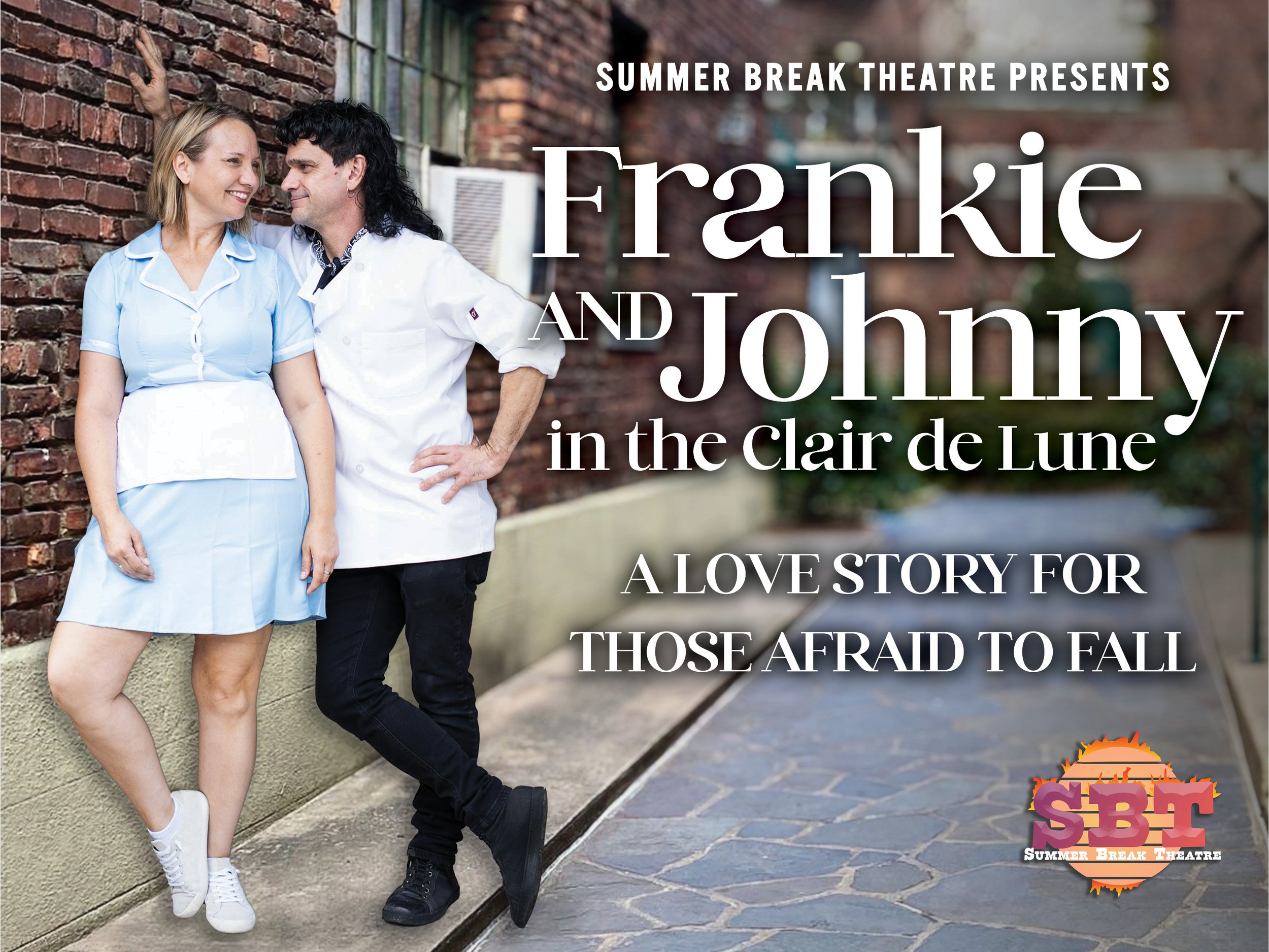 A blonde white woman in a short, pale blue diner-waitress dress and white apron leans against a brick wall, smiling at a white man with a long black mullet wearing a cook’s jacket and black pants, who leans beside her