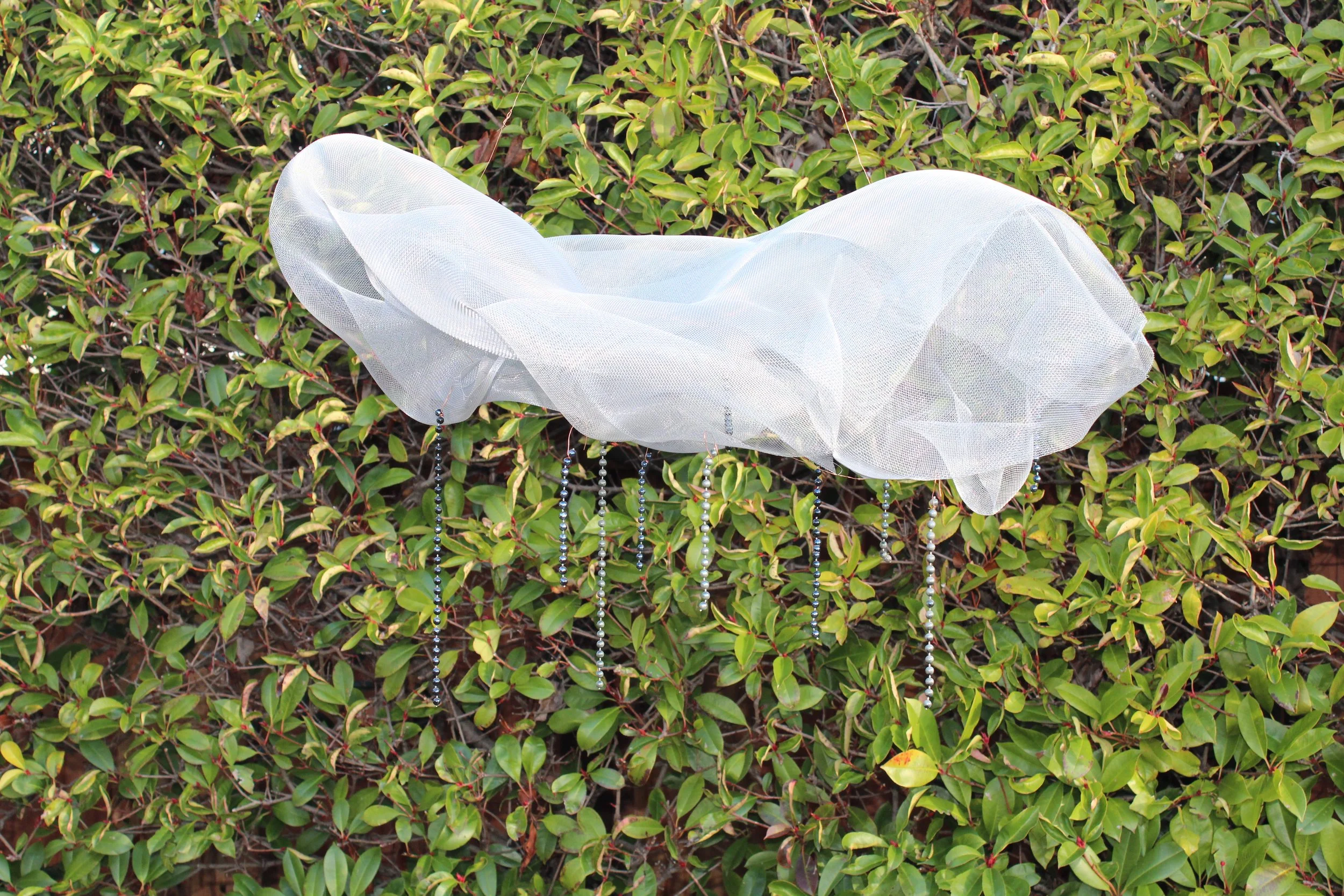 Rain Cloud made from leftover screen door mesh and gifted Mardi Gras