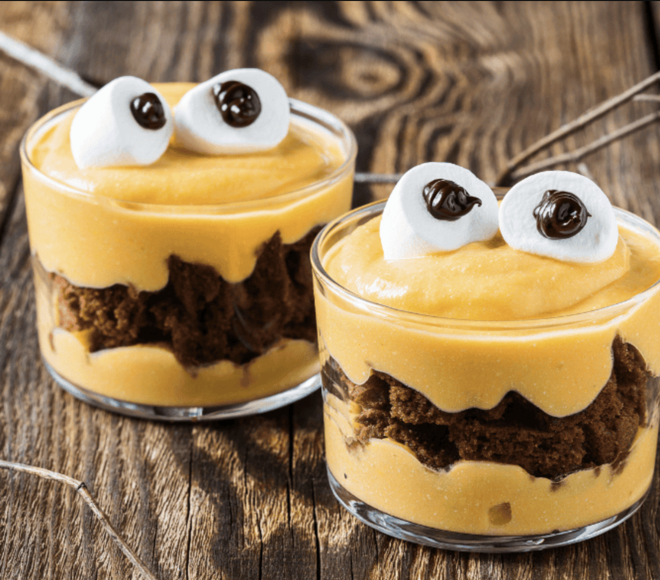 Chocolate cookies decorated with colorful candies and candy eyes to look like reindeer faces.