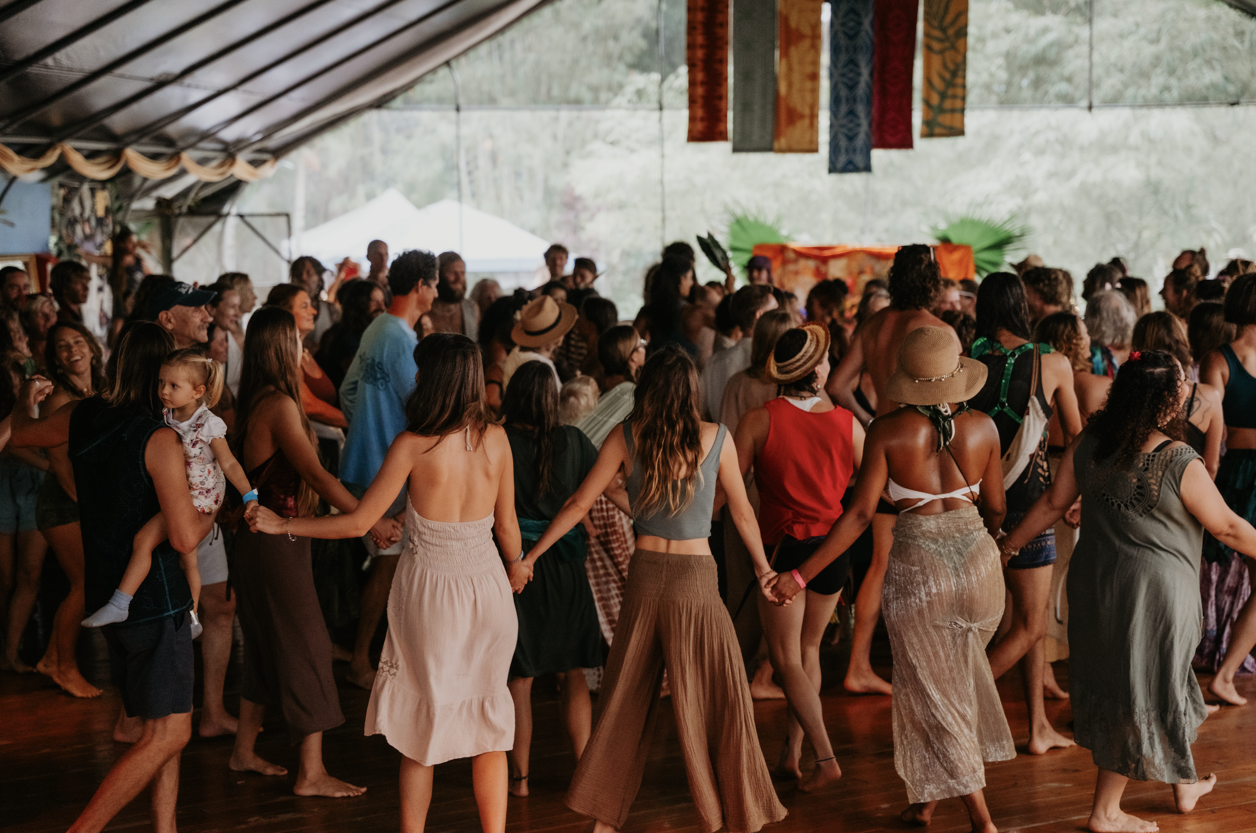 Community Group of people spiral dancing in a large tent, at  ManaFest, a transformational music, dance, arts, and culture festival on Big Island of Hawaii 