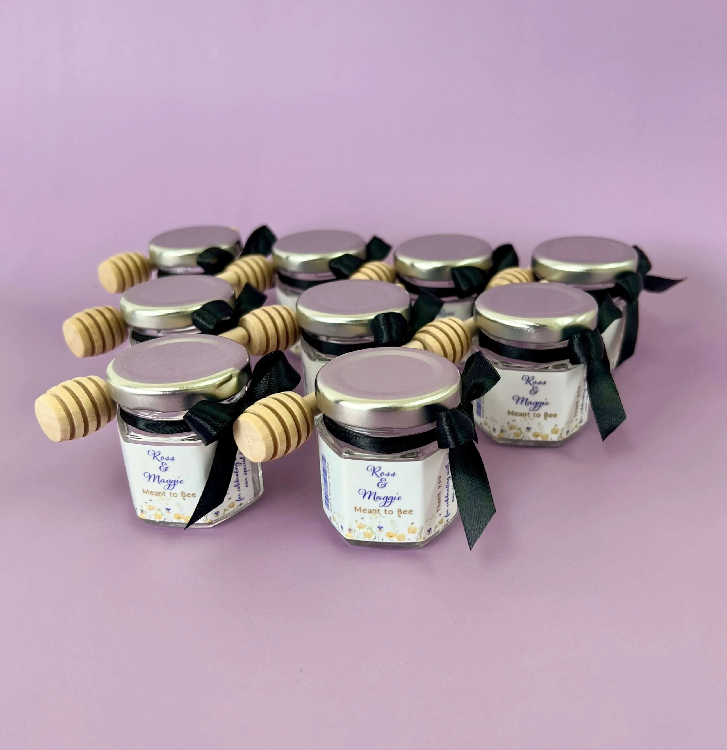 DIY honey jar favour with wooden dipper and satin bow for events