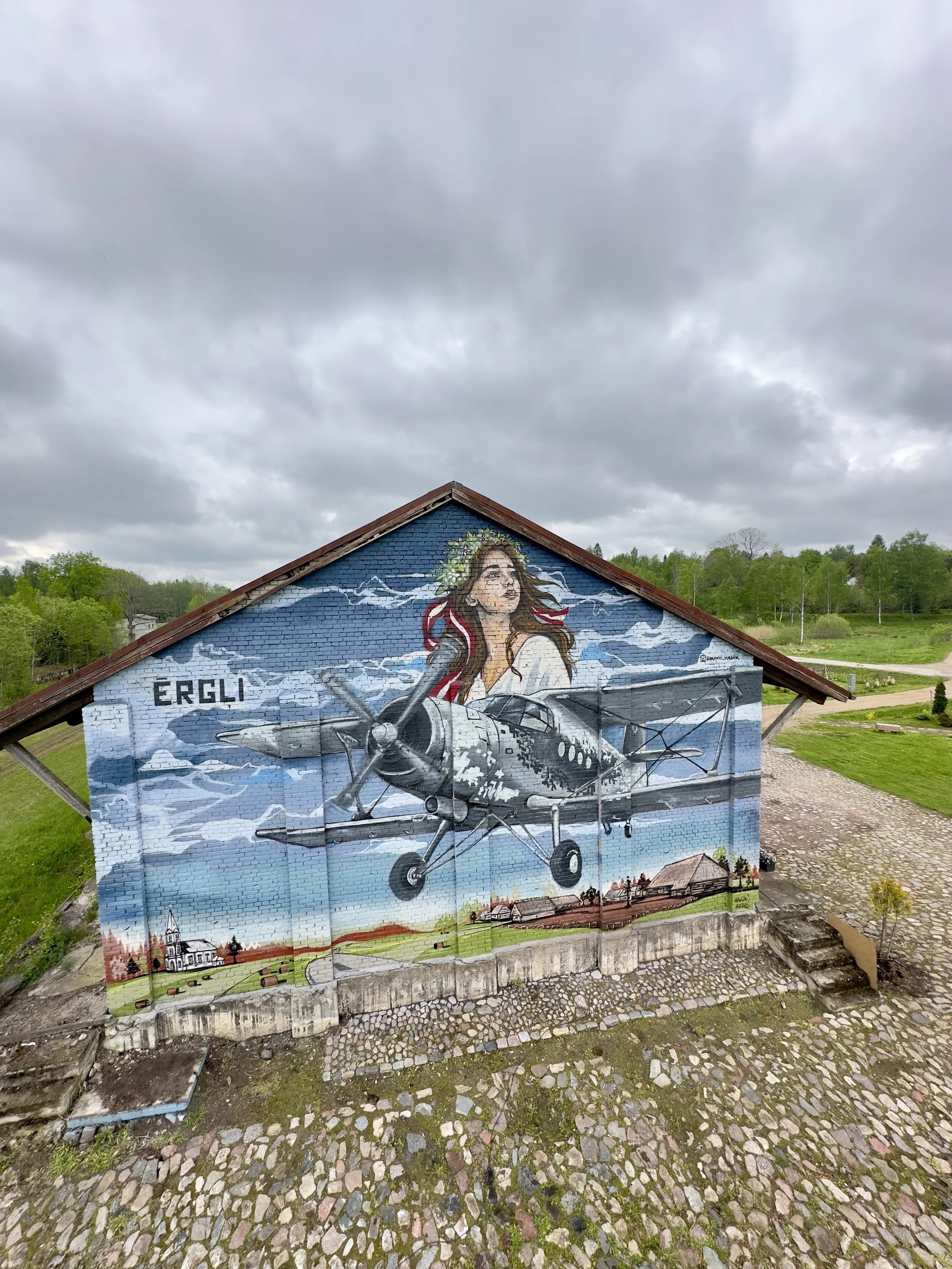 Mural of a Latvian Air Force aircraft on the historic railway station building in Ērgļi, Latvia