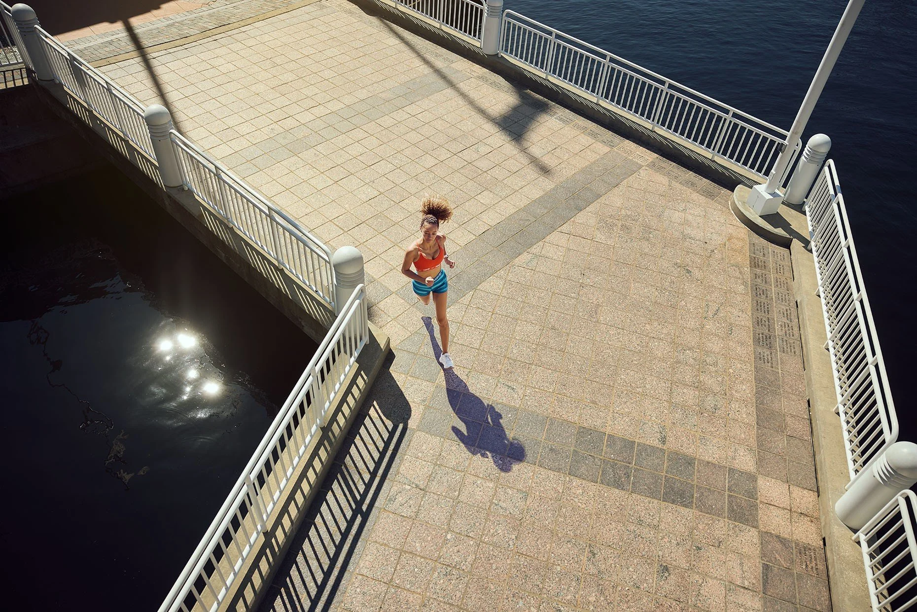 James-Acomb-photographer-overhead-shot-of-woman-running-by-water.jpg