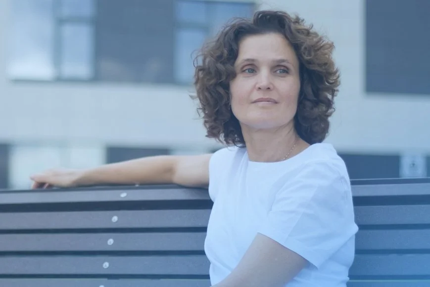 Woman on bench looking into distance representing hormone health after 40. Care are DexaFit West Houston, TX